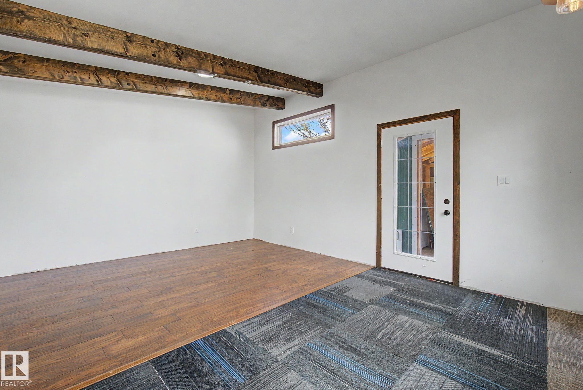 Exposed wood beams accenting the ceiling - 11512 122 St, Edmonton, AB - Indoor Photo Showing Other Room