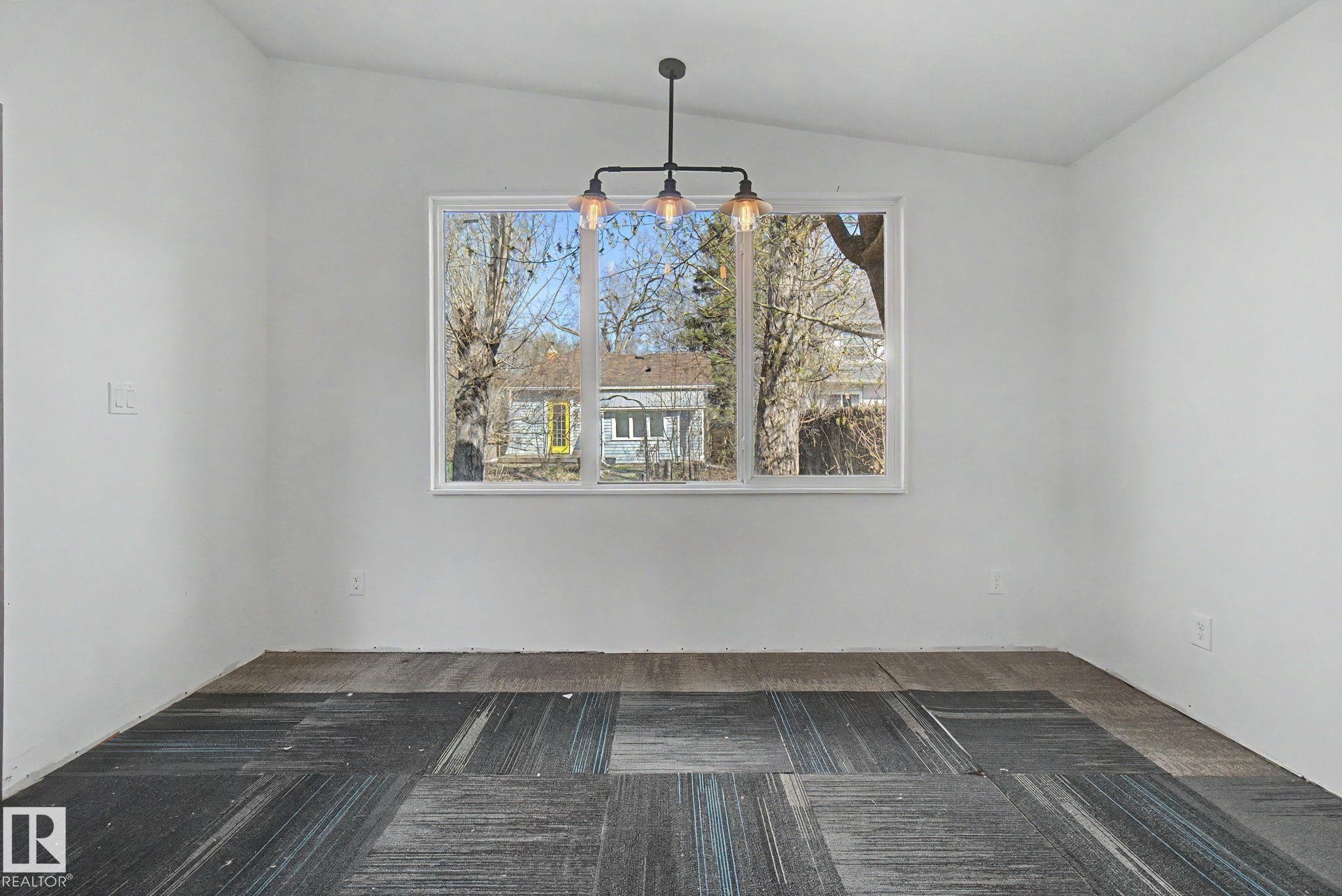 Interior space featuring a white vaulted ceiling and a rectangular window - 11512 122 St, Edmonton, AB - Indoor Photo Showing Other Room