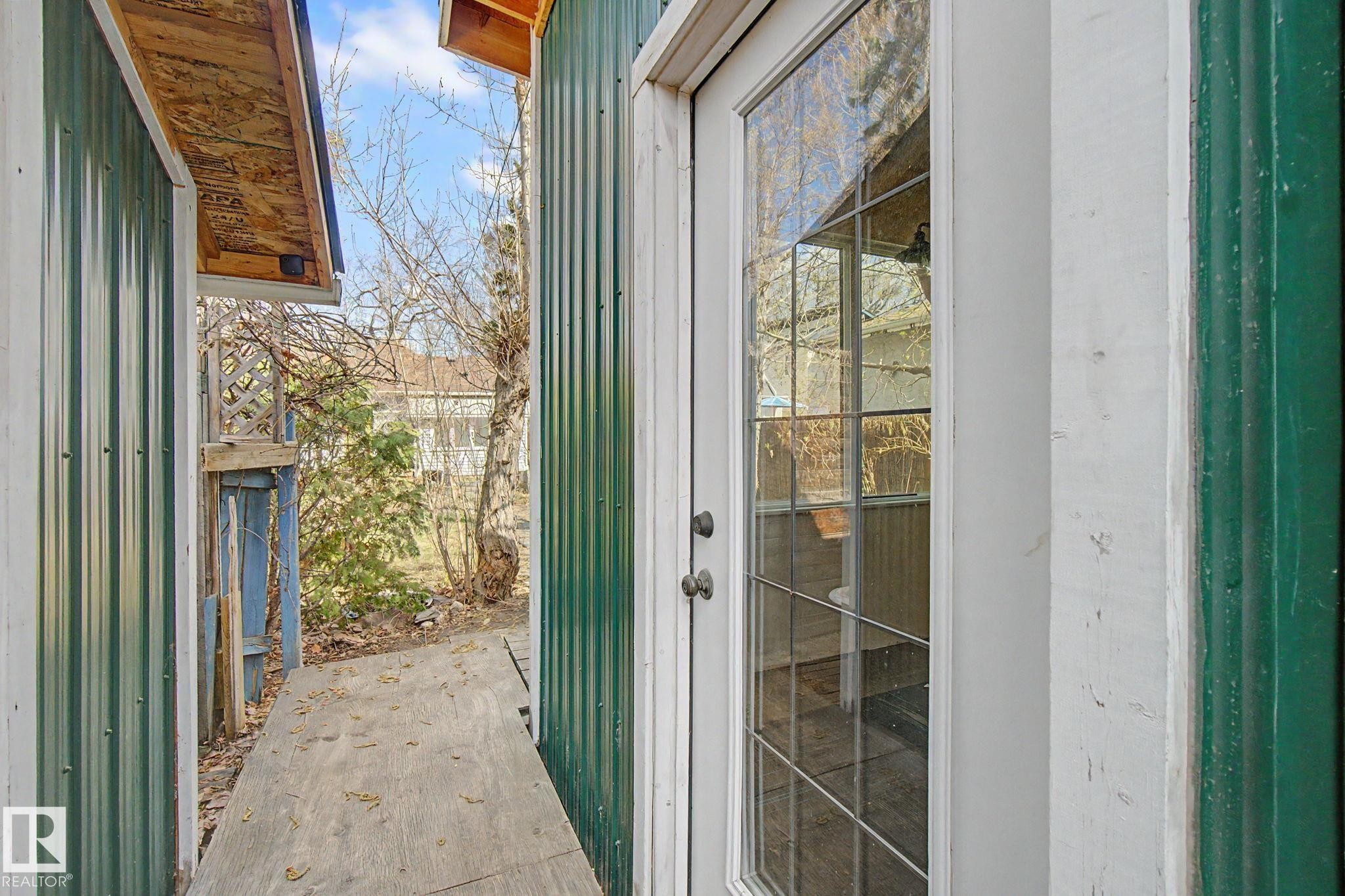 Glass-paned exterior door with white trim - 11512 122 St, Edmonton, AB - With Exterior