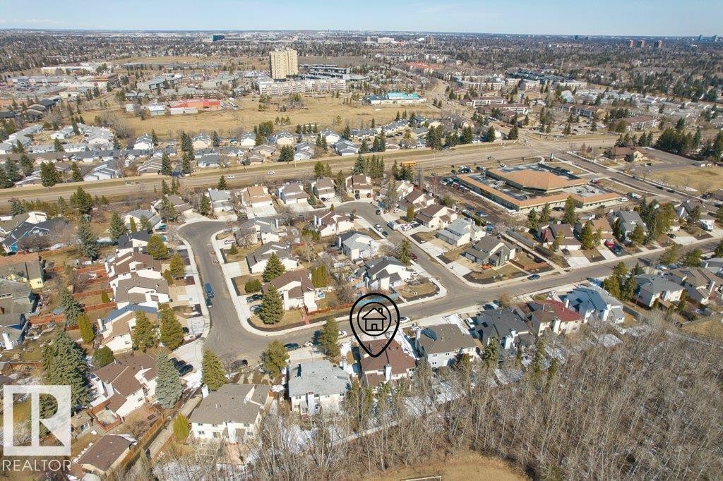 Aerial view highlighting the property within a residential neighborhood featuring established homes and mature trees - 17313 60 Avenue, Edmonton, AB - With View