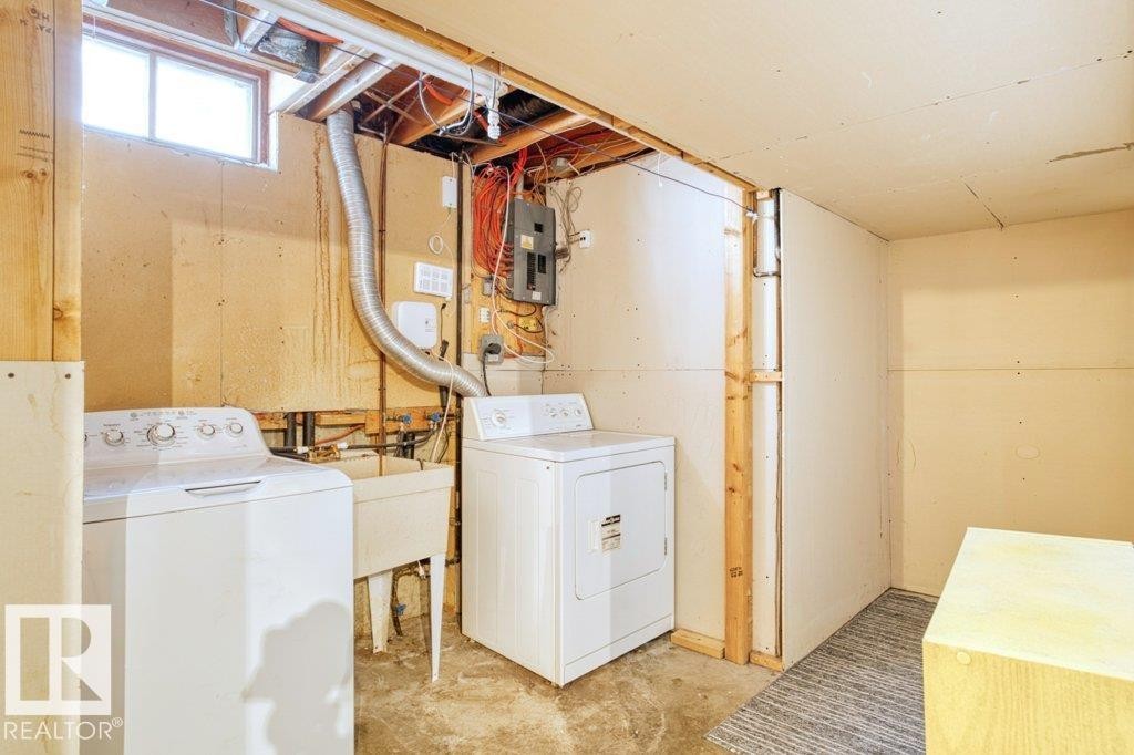 Laundry area featuring a washer, dryer, and utility sink - 17313 60 Avenue, Edmonton, AB - Indoor Photo Showing Laundry Room