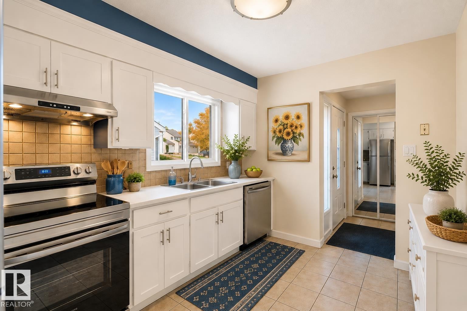 Modern kitchen featuring white cabinetry, stainless steel appliances, a white countertop, and a tiled backsplash - 17313 60 Avenue, Edmonton, AB - Indoor Photo Showing Kitchen With Double Sink