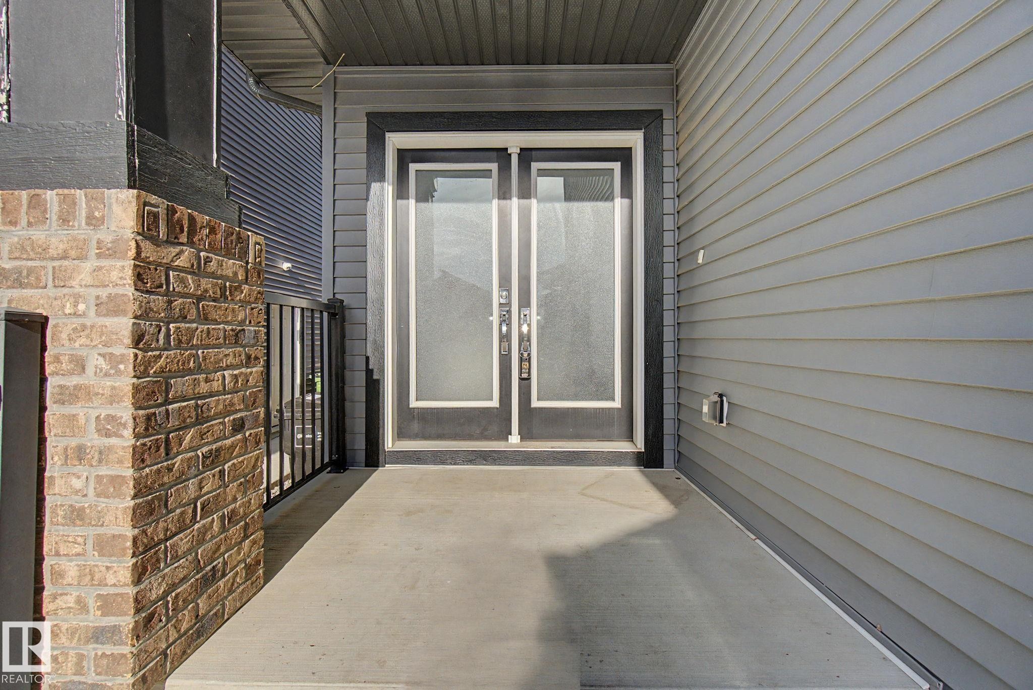 Inviting front entry featuring double doors with frosted glass panels - 635 42 Street, Edmonton, AB - Outdoor With Exterior