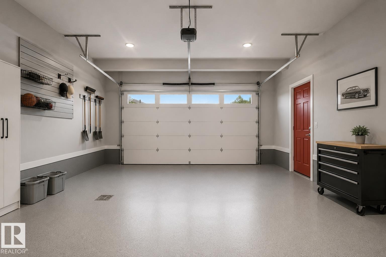 Spacious two-car garage featuring an epoxy-coated concrete floor, an overhead door with transom windows, and recessed ceiling lighting. Virtually Staged. - 635 42 Street, Edmonton, AB - Indoor Photo Showing Garage
