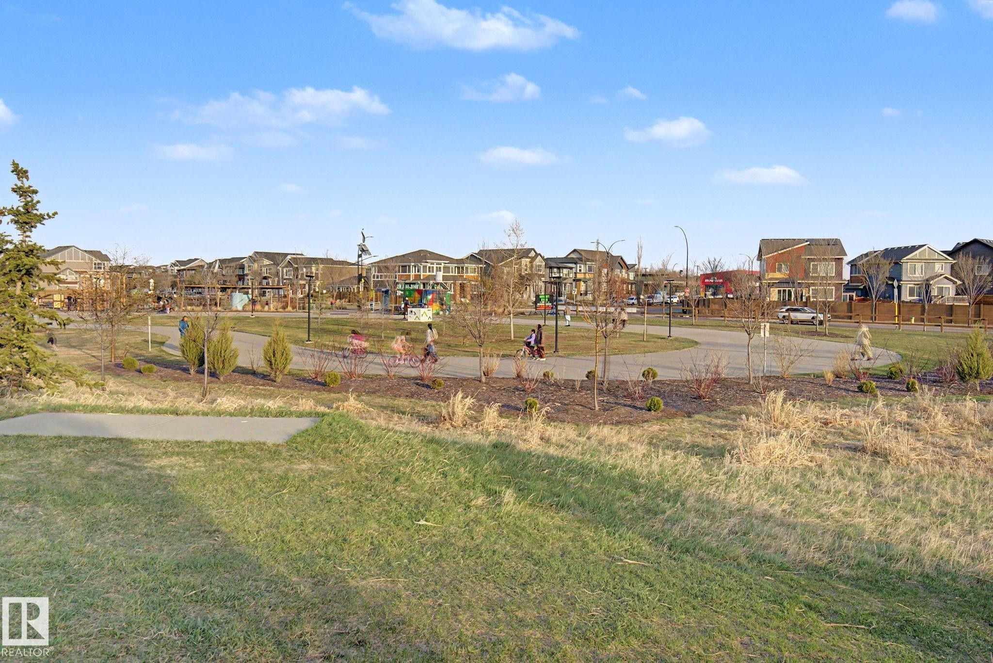 Expansive green space featuring a paved walking path, mature trees, and landscaping - 635 42 Street, Edmonton, AB - Outdoor With View