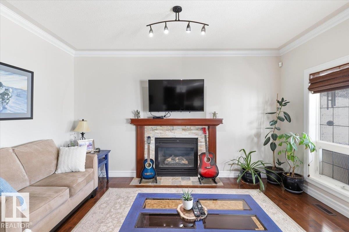 30 Ravine Drive, Devon, AB - Indoor Photo Showing Living Room With Fireplace