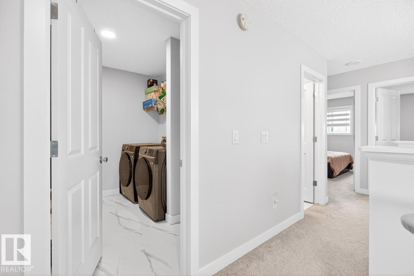 Dedicated laundry area featuring a white door, recessed lighting, and white flooring - 3214 9 Street, Edmonton, AB - Indoor Photo Showing Laundry Room