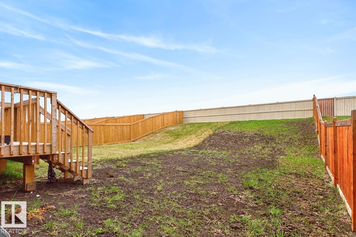 Rear yard with a wooden deck featuring stairs and railing - 3214 9 Street, Edmonton, AB - Outdoor