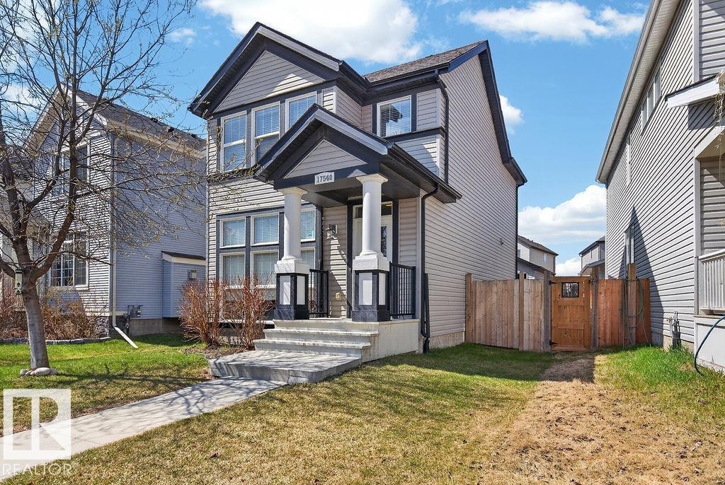 Two-story residence featuring light gray siding with dark trim accents - 17540 58 Street Nw, Edmonton, AB