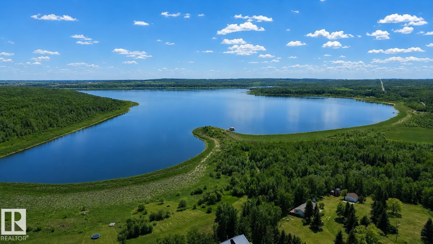 Expansive body of water surrounded by dense green forestry - 331 60417 Range Road 124, Rural St. Paul County, AB