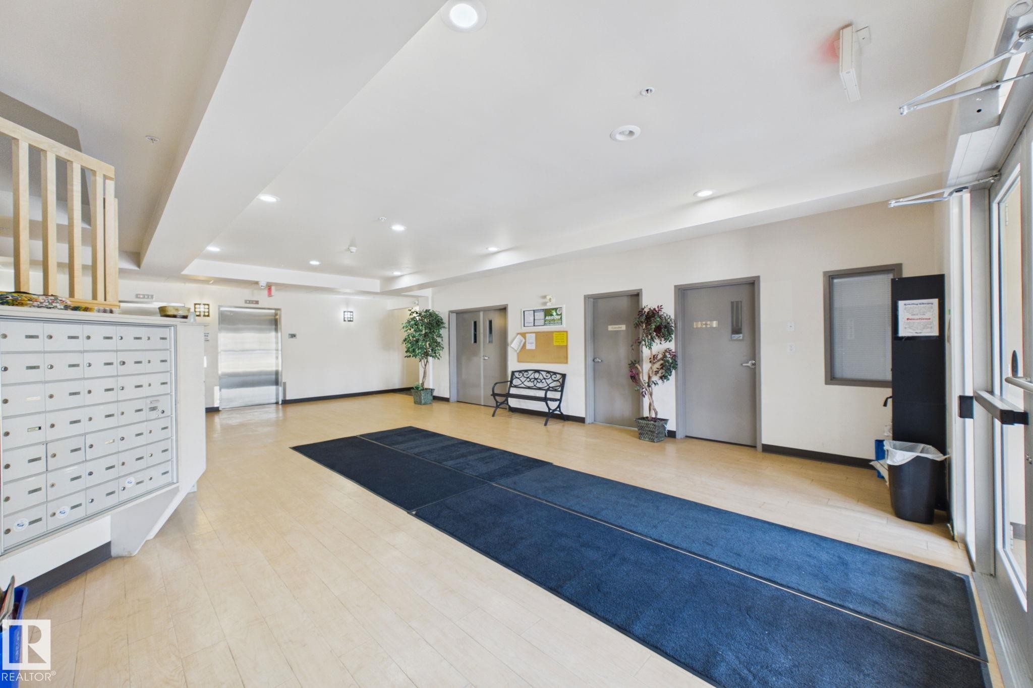 Entryway featuring wood-finish flooring, recessed lighting, and a mail center - 220 80A Kelloway Crescent, Red Deer, AB - Indoor Photo Showing Other Room