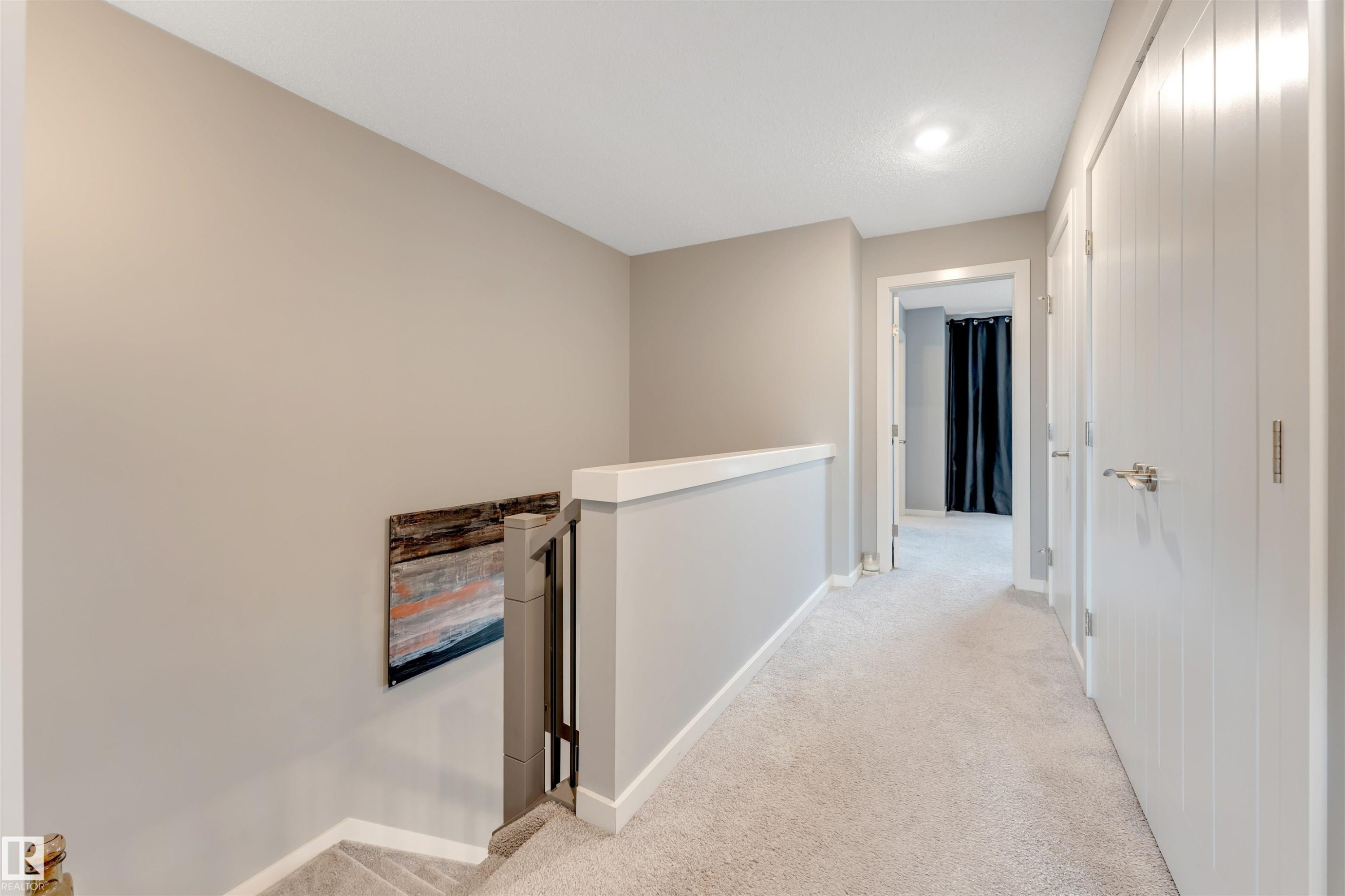 Upper-level hallway featuring light gray carpet flooring, neutral painted walls, white trim, and recessed lighting - 2652 Maple Way, Edmonton, AB - Indoor Photo Showing Other Room
