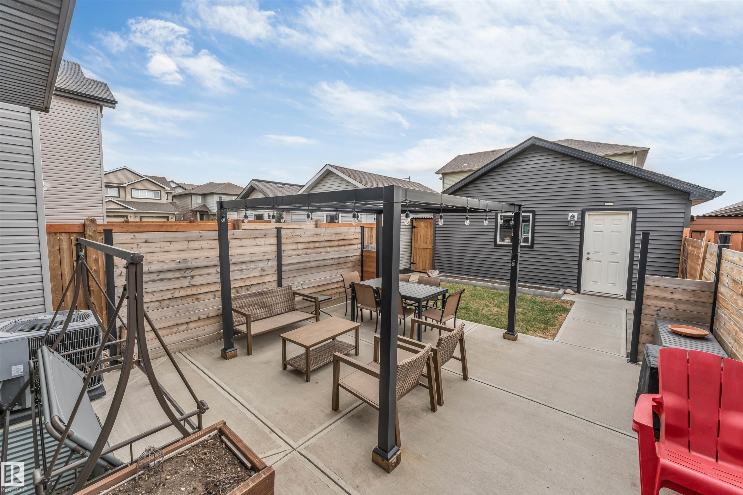 Concrete patio featuring a modern pergola with string lighting - 2652 Maple Way, Edmonton, AB - Outdoor With Deck Patio Veranda With Exterior
