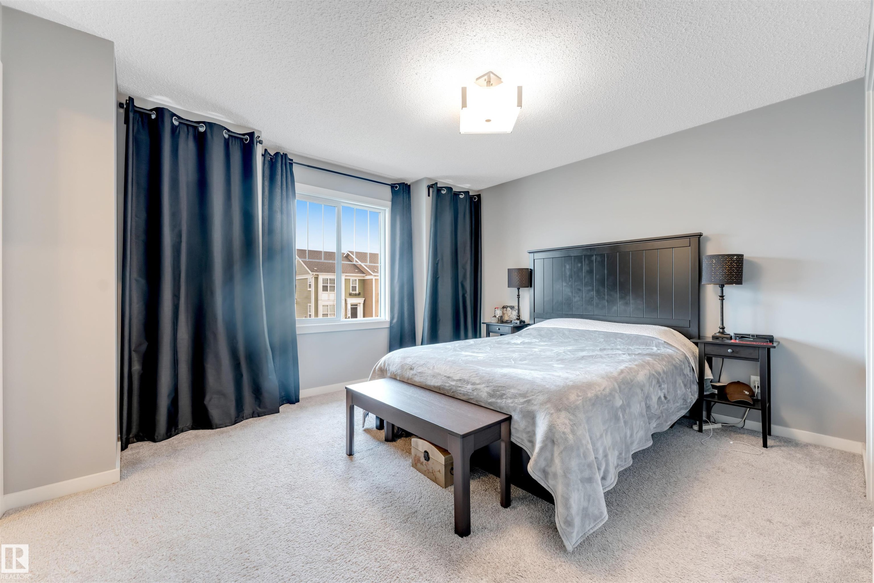 Bright bedroom featuring light gray painted walls and light-toned carpeting - 2652 Maple Way, Edmonton, AB - Indoor Photo Showing Bedroom