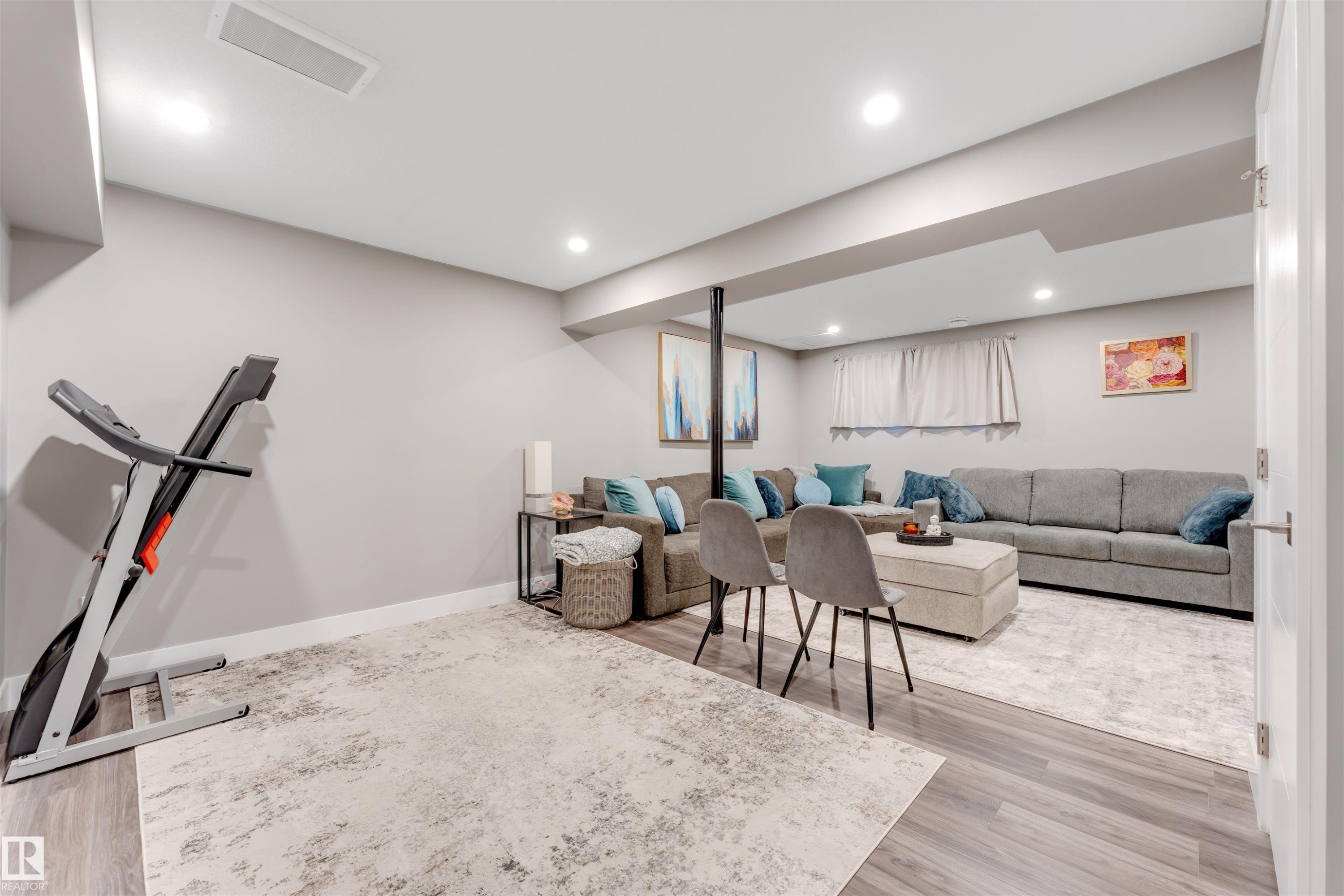 Spacious lower-level area with light-toned walls and wood-finish flooring - 2652 Maple Way, Edmonton, AB - Indoor Photo Showing Basement