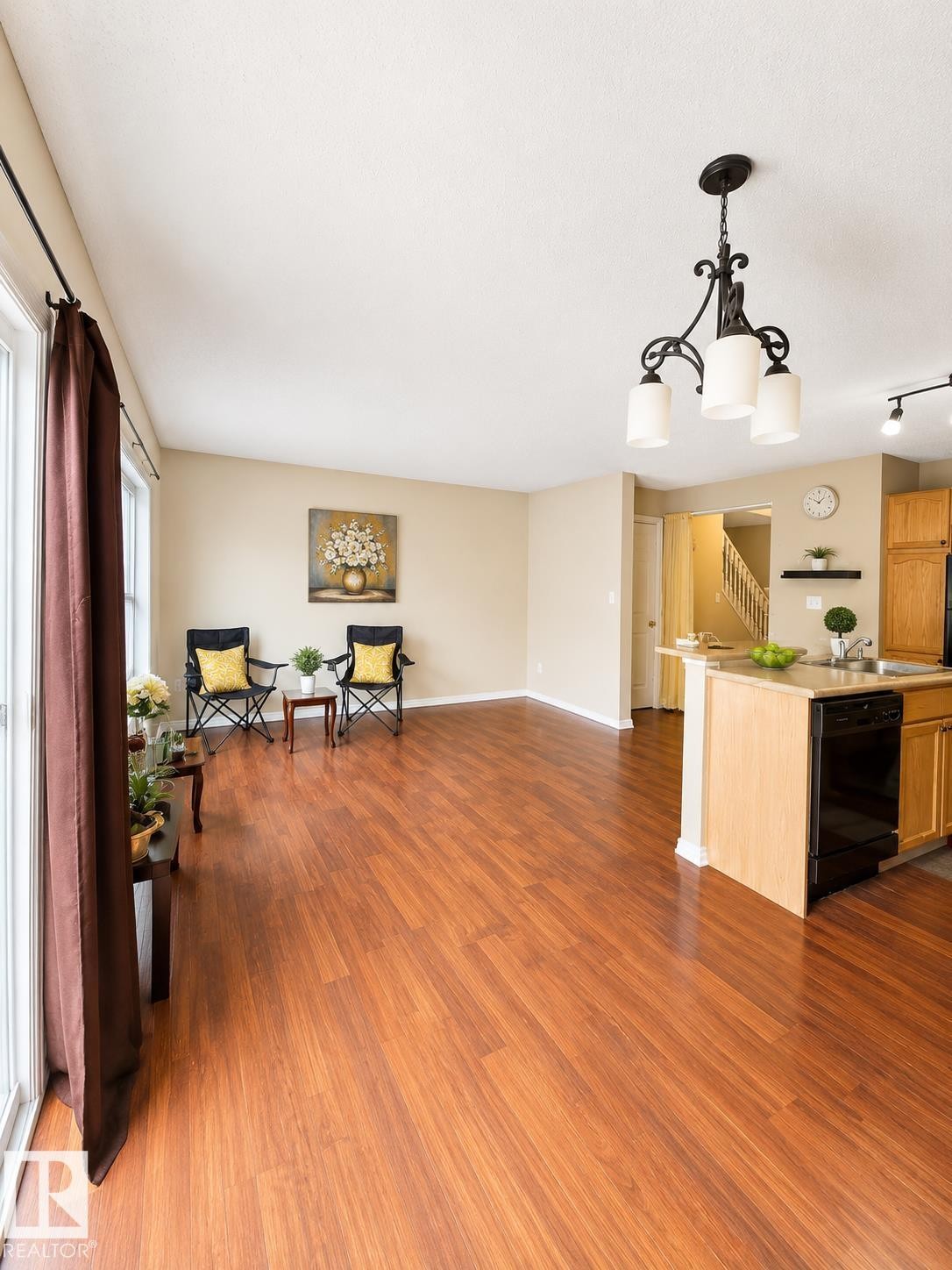 Spacious living area featuring wood-finish flooring - 704 83 Street, Edmonton, AB - Indoor
