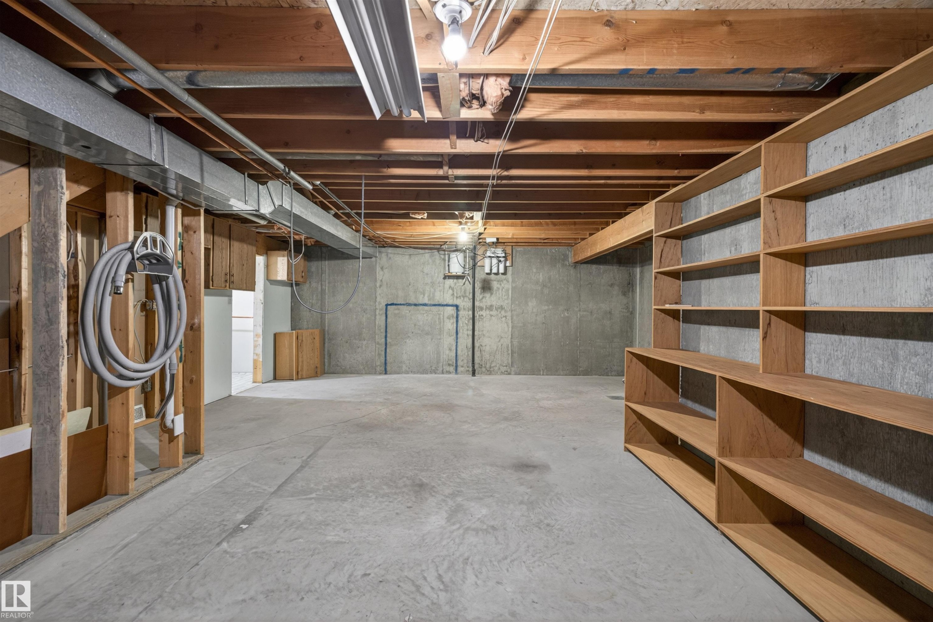 Unfinished basement with exposed ceiling joists and concrete flooring - 19403 Fort Road, Edmonton, AB - Indoor Photo Showing Basement