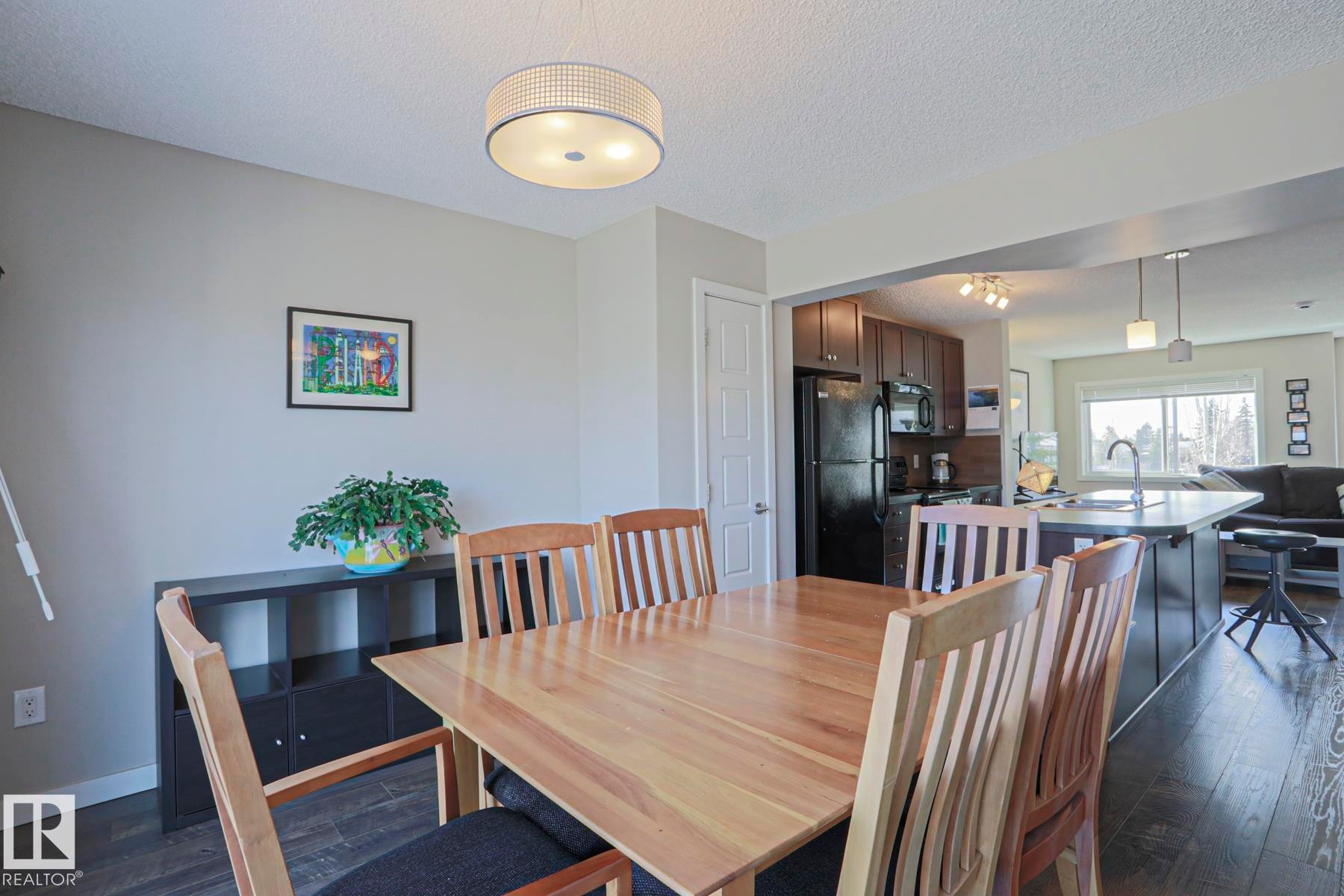 Open-concept with direct sightlines to the kitchen and living spaces makes for great entertaining - 1622 33A Street Nw, Edmonton, AB - Indoor Photo Showing Dining Room