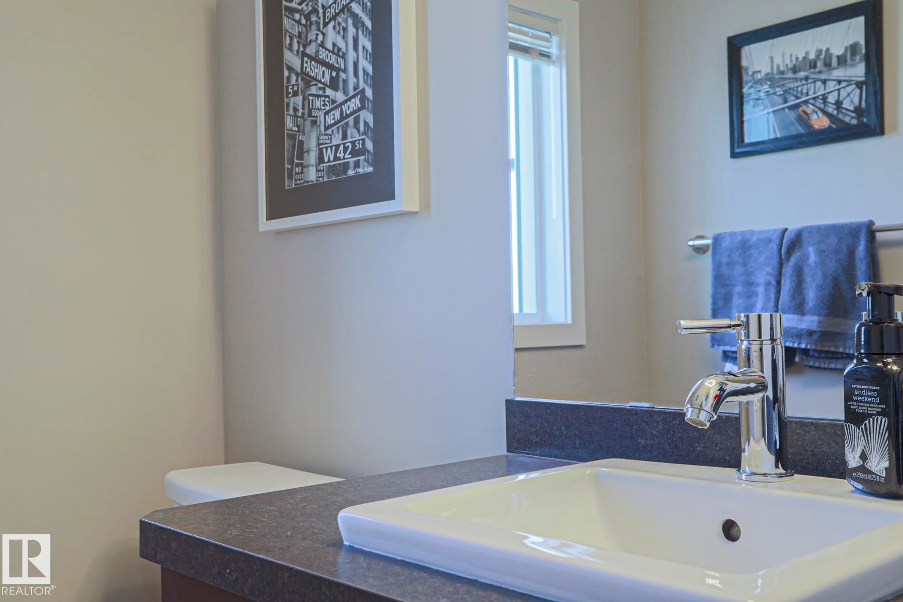 Convenient Main living area 2 piece Bathroom vanity featuring a rectangular undermount sink and a polished chrome faucet - 1622 33A Street Nw, Edmonton, AB - Indoor Photo Showing Bathroom