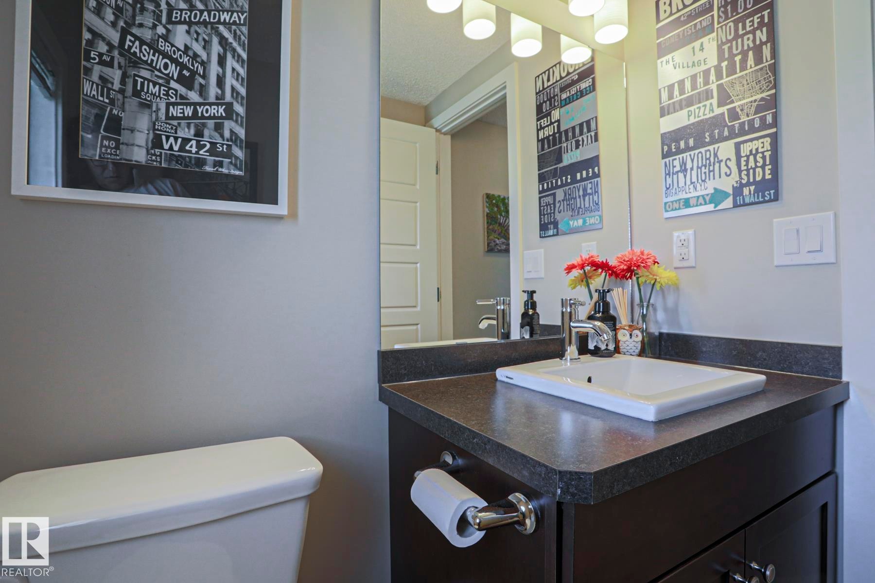 Main 2 piece Bathroom featuring a dark wood-finish vanity with a rectangular sink and dark countertop - 1622 33A Street Nw, Edmonton, AB - Indoor Photo Showing Bathroom