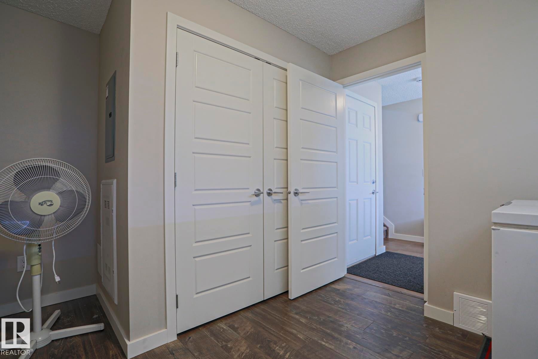 Laminate flooring throughout Main floor storage and furnace room with access to the double garage. - 1622 33A Street Nw, Edmonton, AB - Indoor