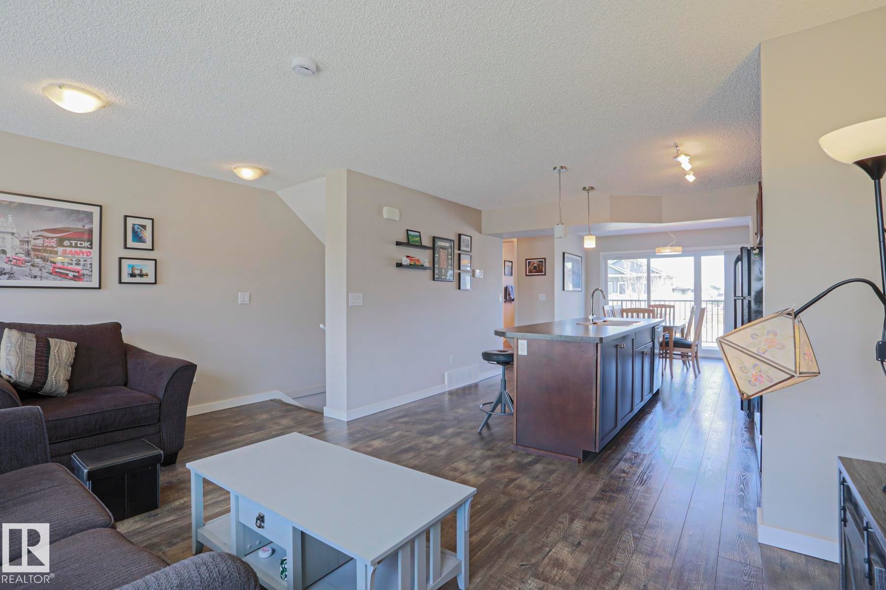 Open-concept living space featuring laminate flooring - 1622 33A Street Nw, Edmonton, AB - Indoor Photo Showing Living Room
