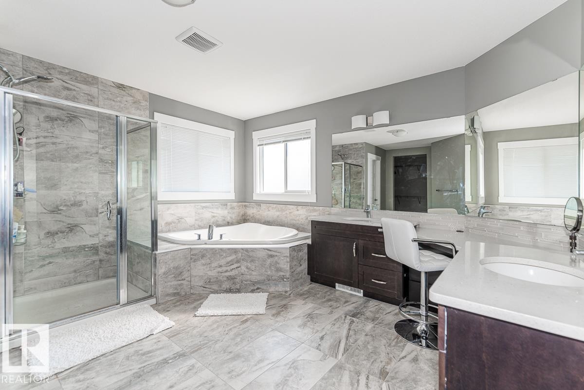 Spacious bathroom featuring large format tile flooring and a glass-enclosed shower - 9748 205 Street, Edmonton, AB - Indoor Photo Showing Bathroom