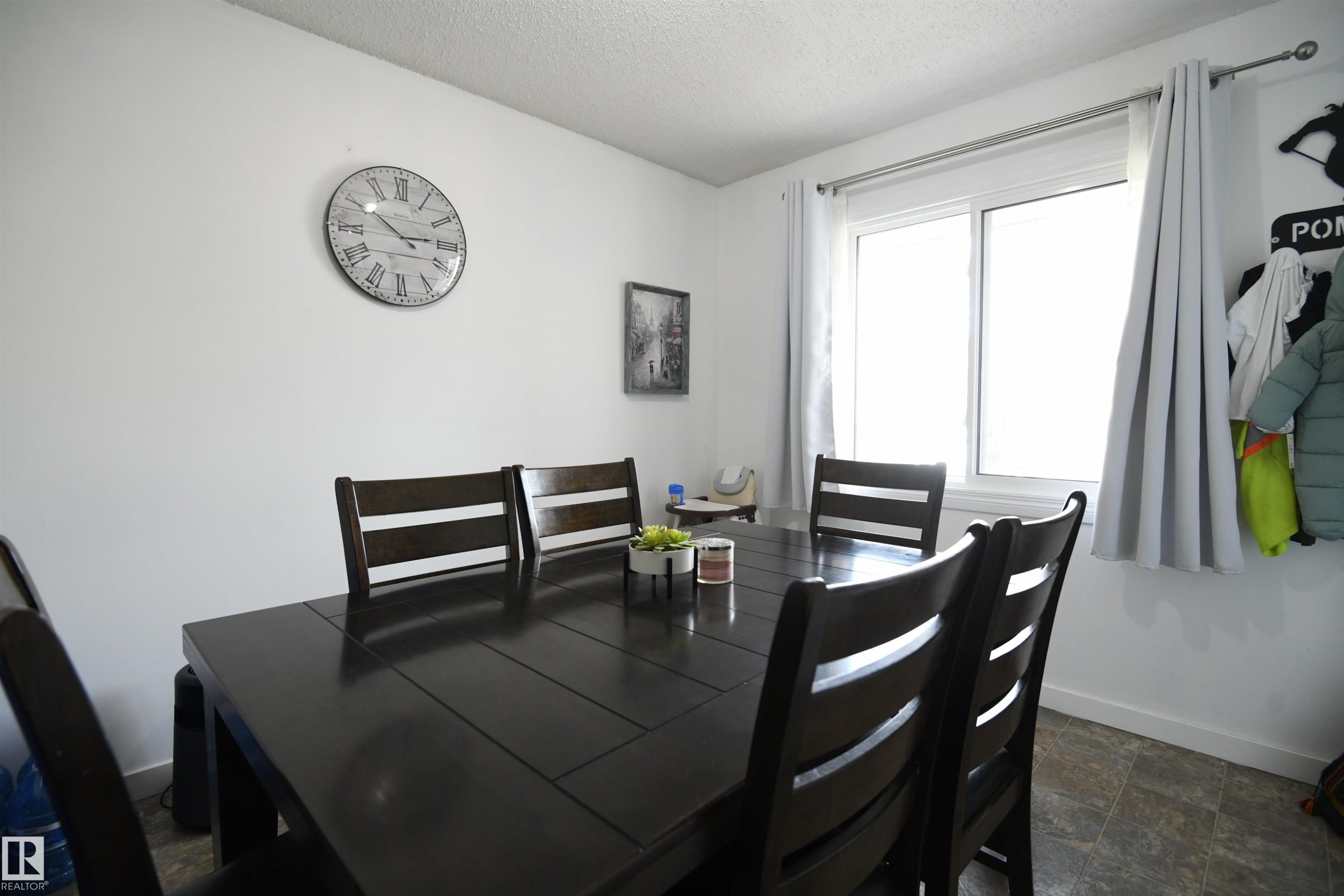 Townhomes often lack a large eating area. Not here. This unit features a large, family sized dining room, that easily supports a proper, family sized table. A large window also looks out into the private yard and patio area - 5823 Riverbend Road, Edmonton, AB - Indoor Photo Showing Dining Room