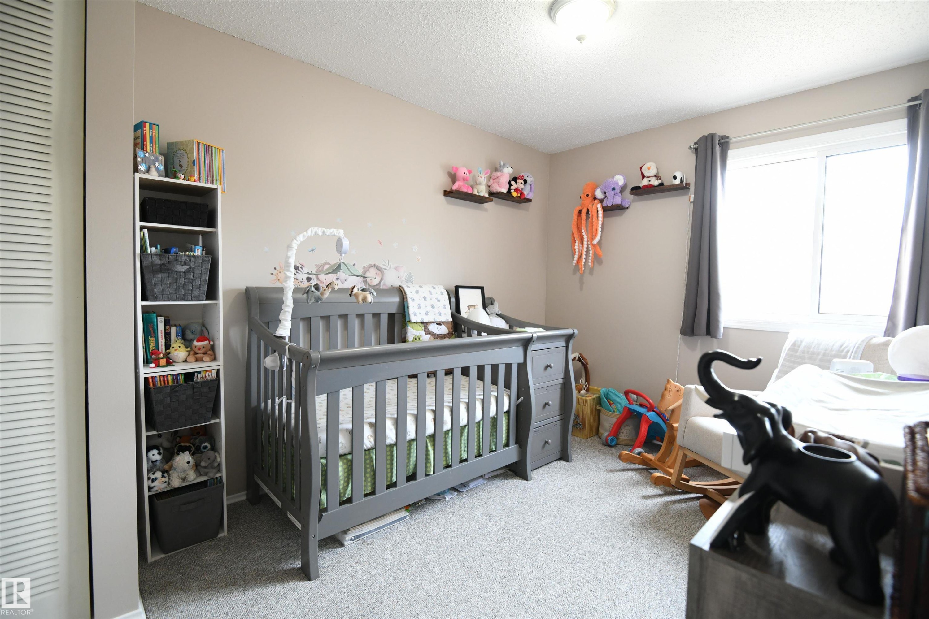With a total of three bedrooms, this home works well for a family, or anyone who just needs some extra space. Bright windows and neutral tones throughout - 5823 Riverbend Road, Edmonton, AB - Indoor Photo Showing Bedroom