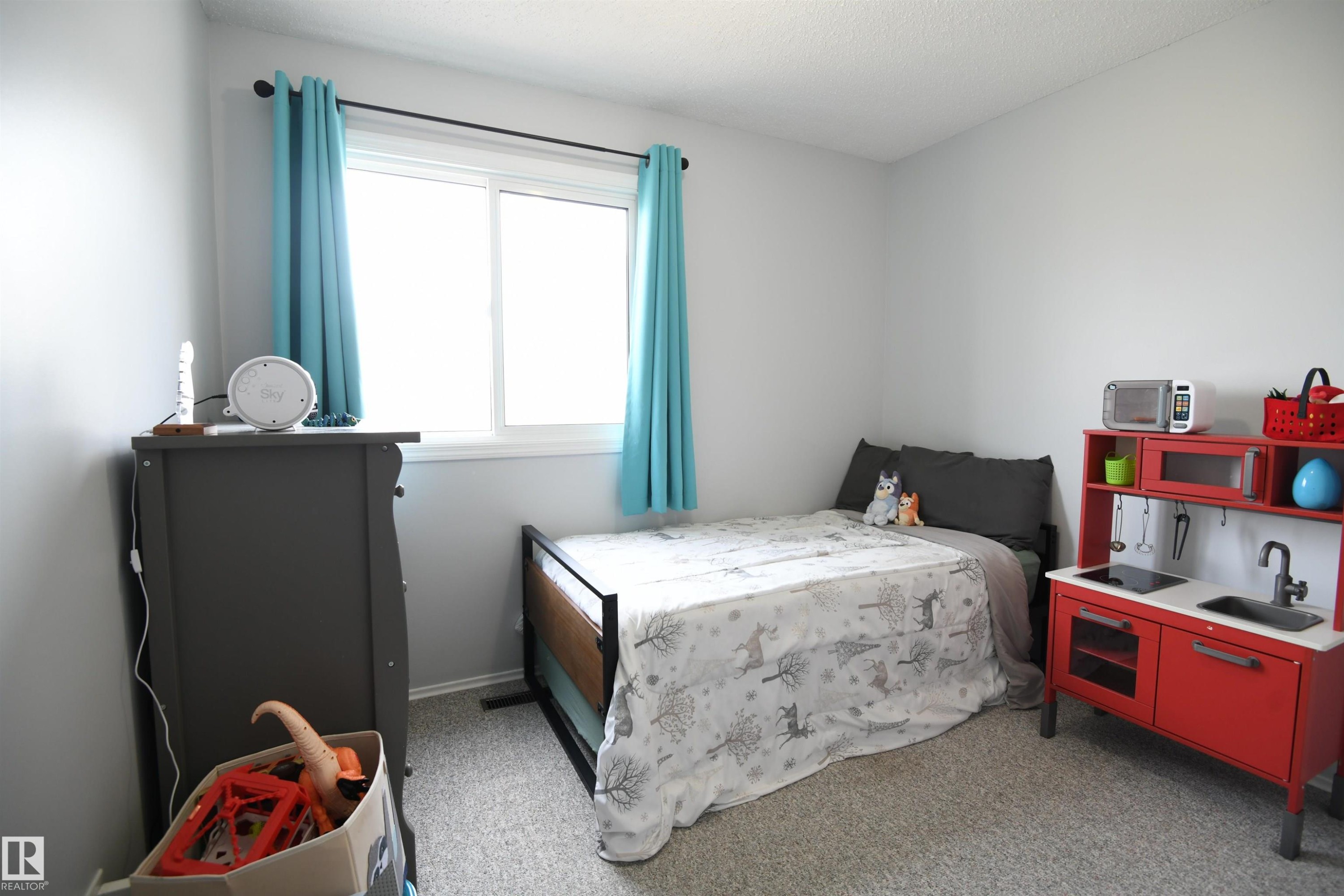 With a total of three bedrooms, this home works well for a family, or anyone who just needs some extra space. Bright windows and neutral tones throughout - 5823 Riverbend Road, Edmonton, AB - Indoor Photo Showing Bedroom