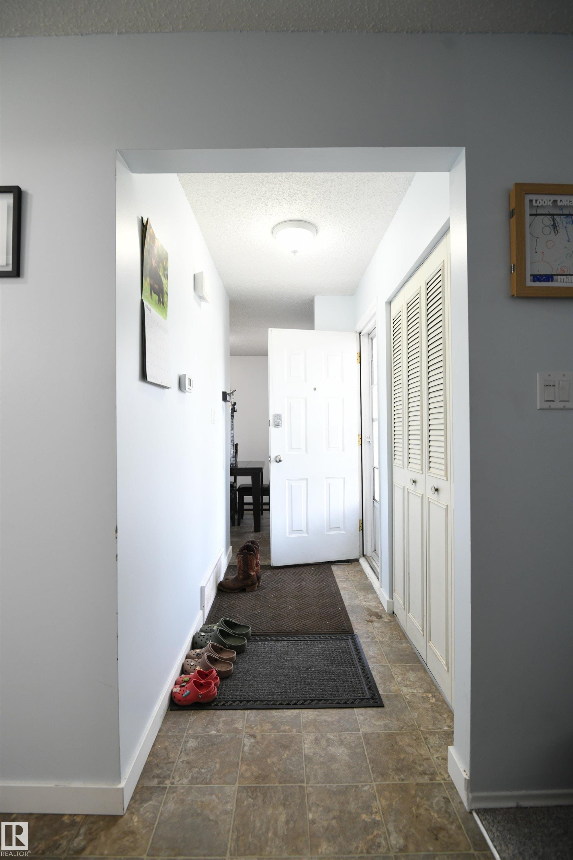 Rather than a front door that just enters into the living space, this proper entrance is a welcome treat, especially in a busy household. Lots of room for shoes, boots, and coats - 5823 Riverbend Road, Edmonton, AB - Indoor Photo Showing Other Room