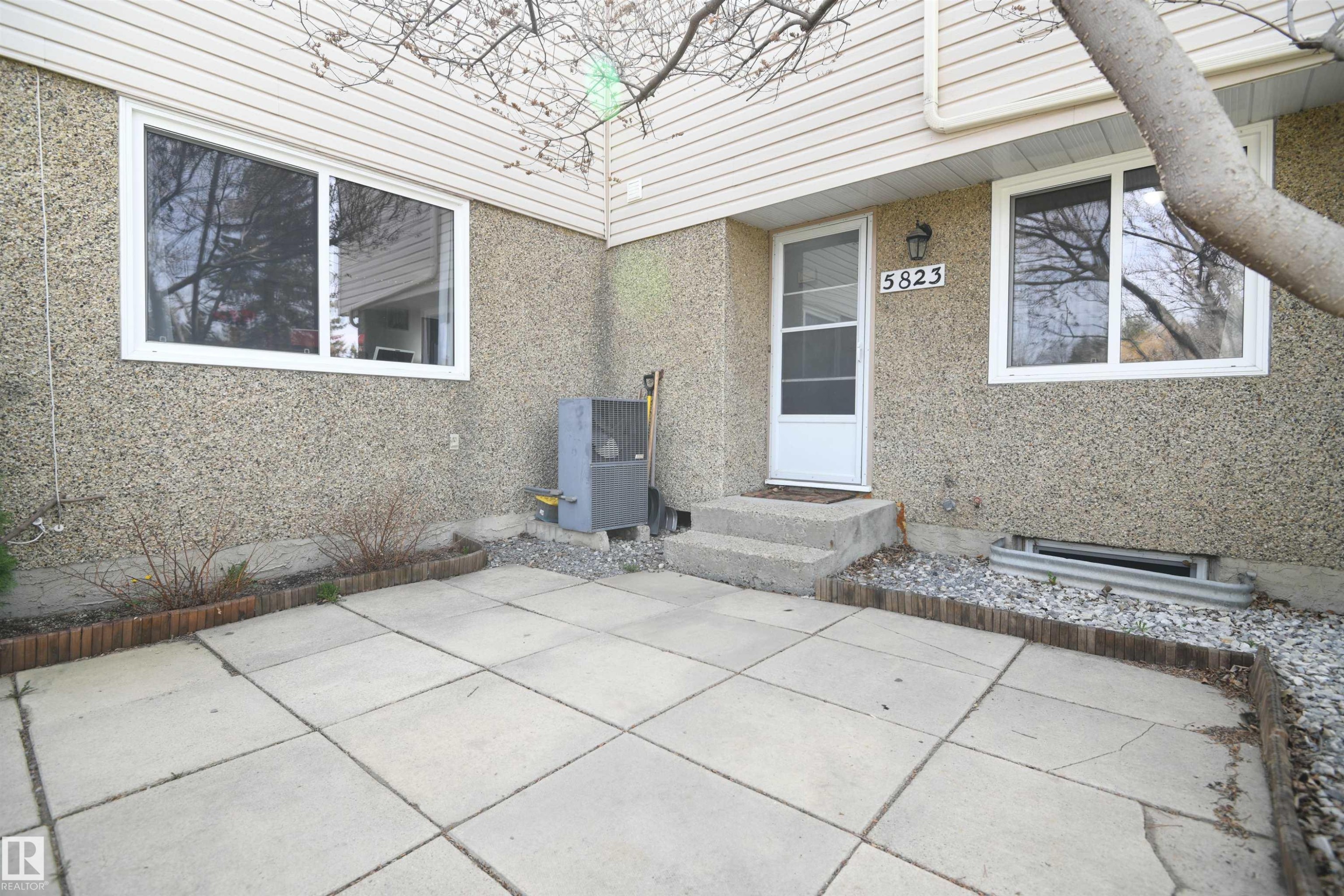 The yard / patio is fully fenced, and private. And when you want to enjoy some more open space and lawn, just step through the gate and into the huge green space with it's paved trail, just outside your door - 5823 Riverbend Road, Edmonton, AB - Outdoor With Exterior