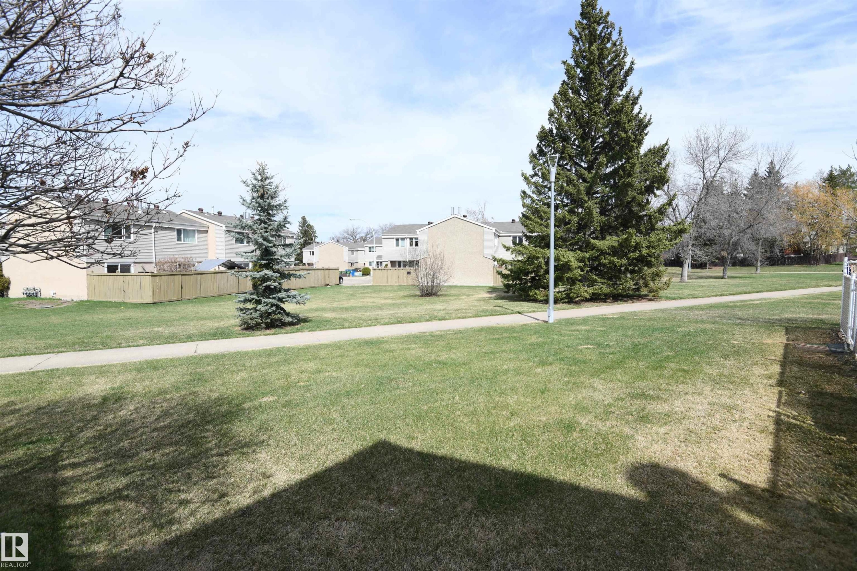 This unit is located immediately adjacent to this large, open, green space, and the paved trail allows you to explore Brander Gardens whenever you like. The treed off leash area is also accessed from this paved pathway - 5823 Riverbend Road, Edmonton, AB - Outdoor