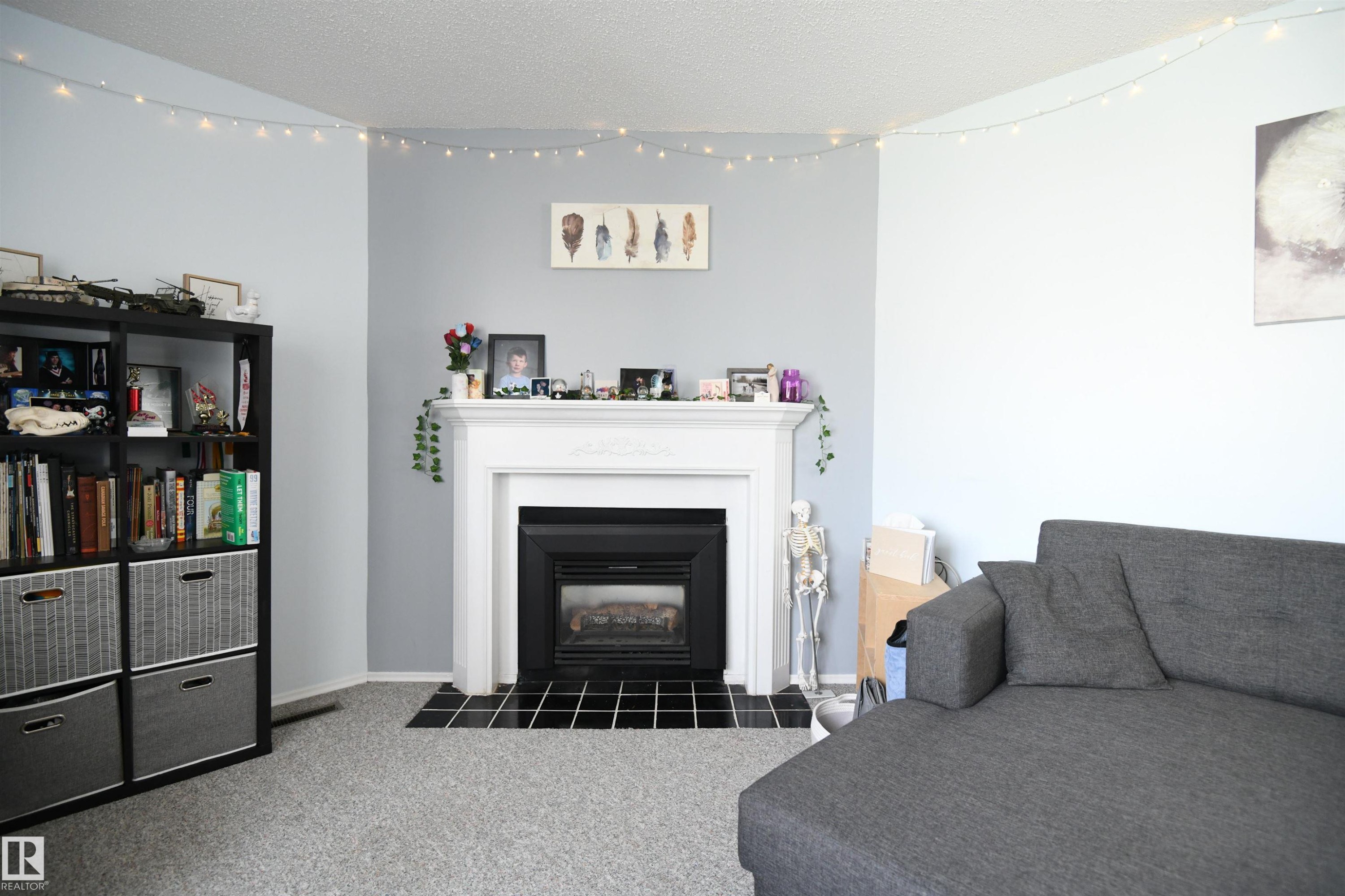 The gas fireplace is a very nice touch, and gives the living room a very warm and inviting feel - 5823 Riverbend Road, Edmonton, AB - Indoor Photo Showing Living Room With Fireplace
