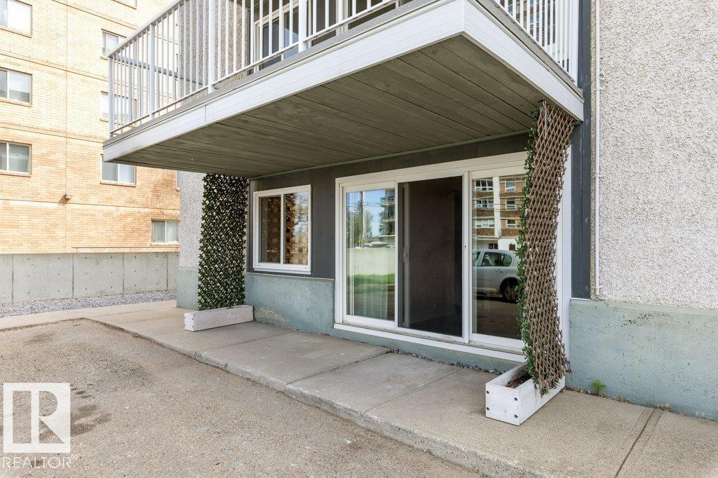 Ground-level patio with sliding glass door access - 101 8604 Gateway Boulevard, Edmonton, AB - Outdoor With Exterior