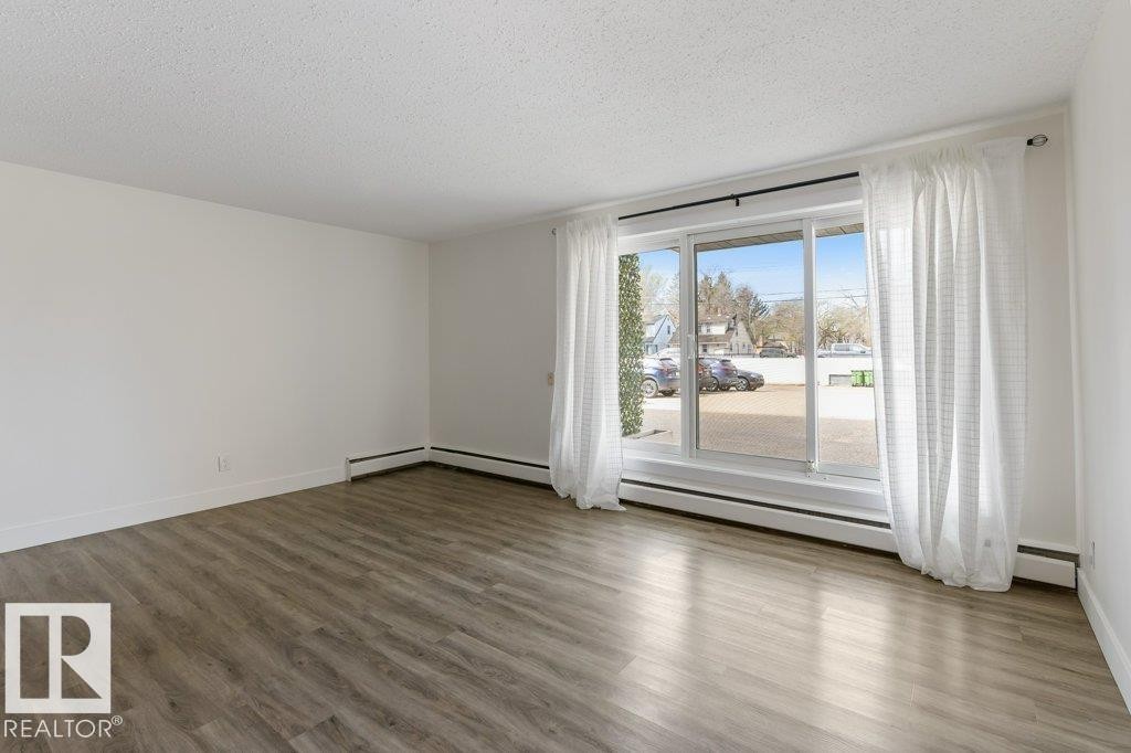 Open-concept living space; Carpet-Free Condo; West Facing Patio Door; - 101 8604 Gateway Boulevard, Edmonton, AB - Indoor Photo Showing Other Room