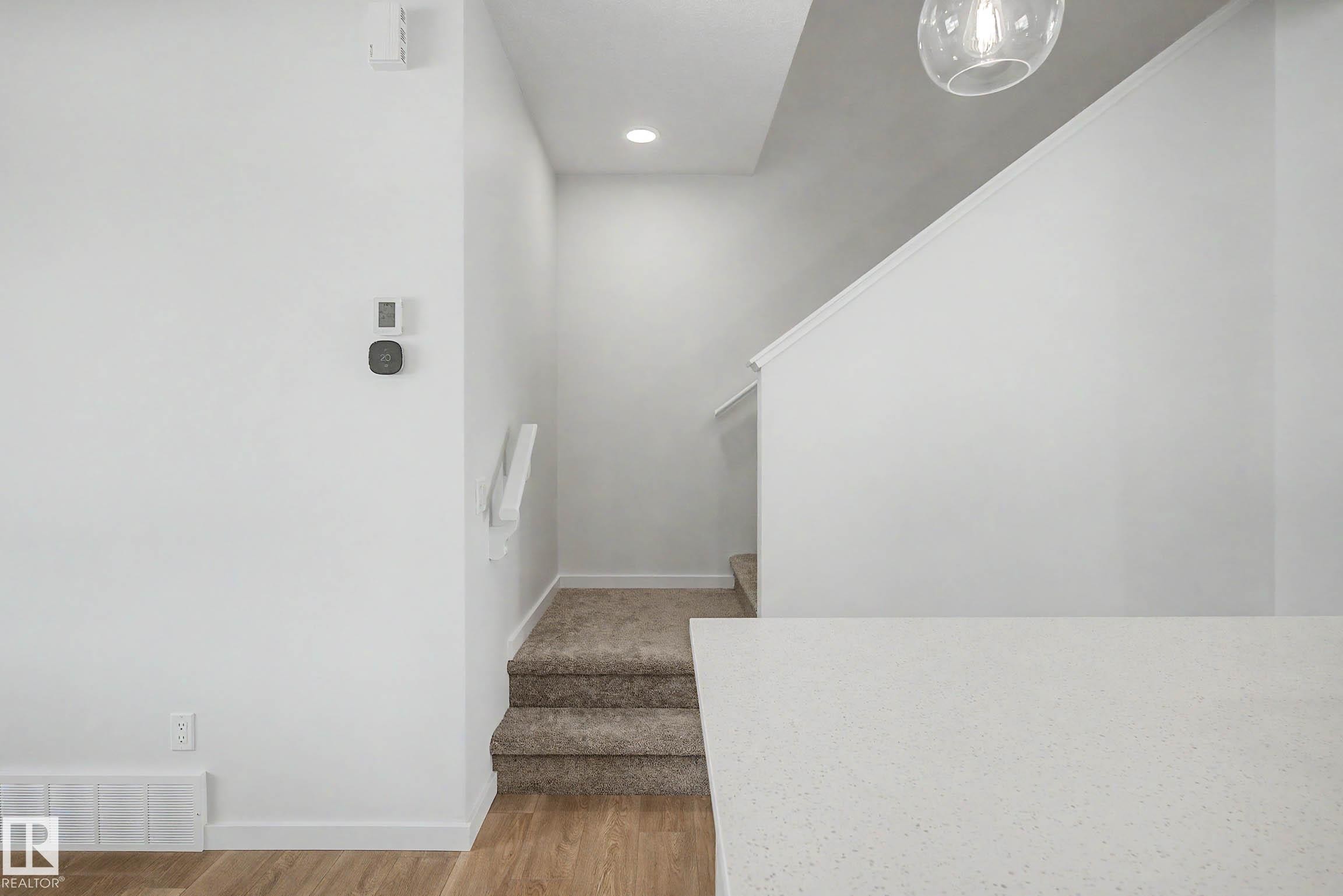 Carpeted staircase with white handrail and recessed lighting - 720 Southfork Drive, Leduc, AB - Indoor Photo Showing Other Room