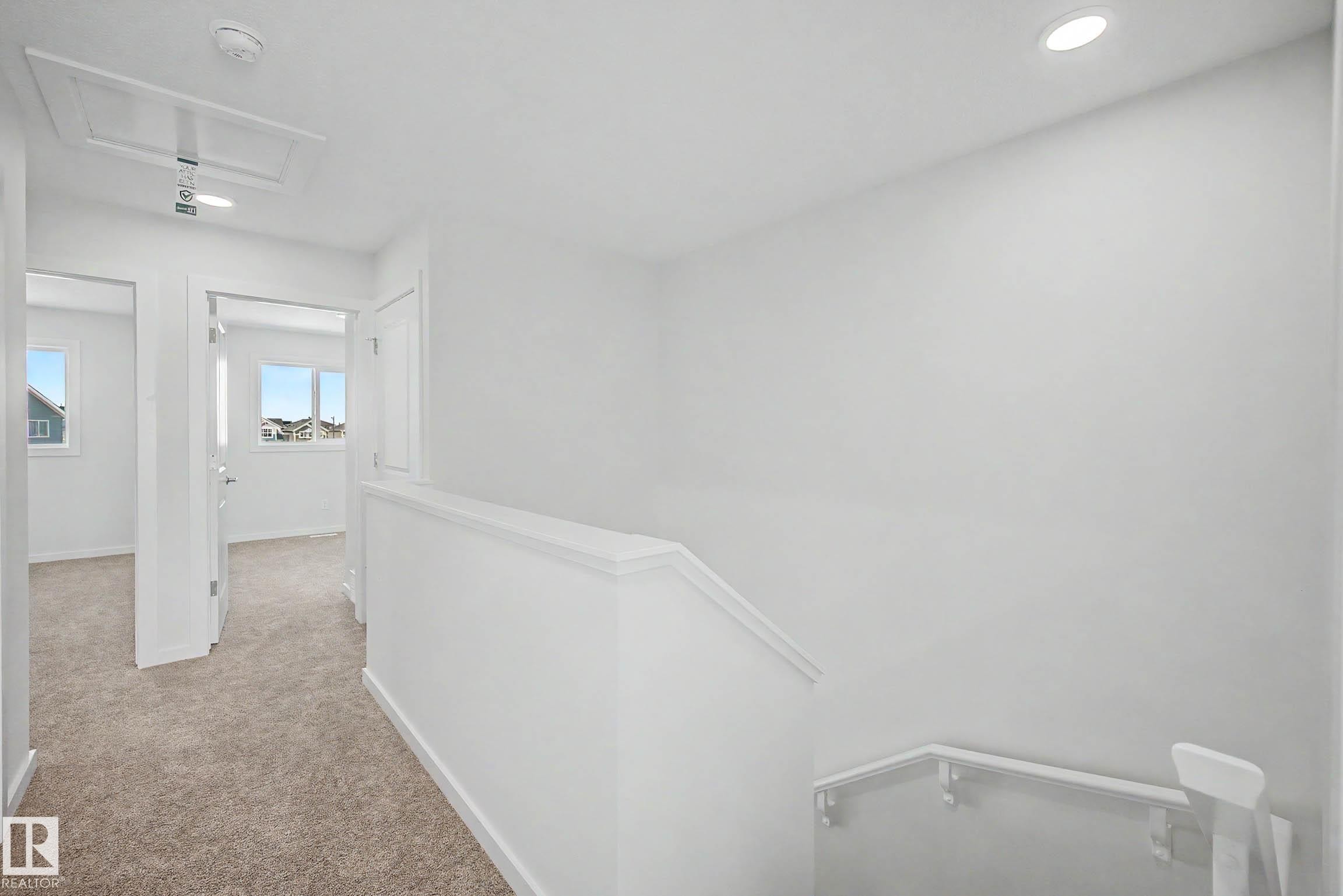 Upper-level hallway featuring neutral carpeting, recessed lighting, and white painted walls - 720 Southfork Drive, Leduc, AB - Indoor Photo Showing Other Room