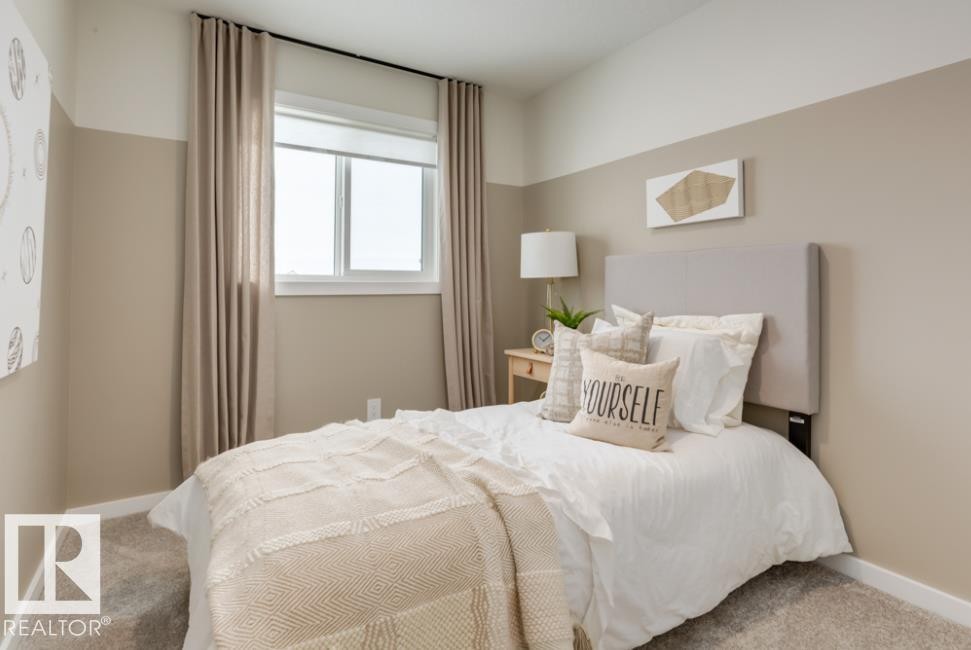Bedroom featuring a neutral two-tone wall design, a window with roller blind and drapery, and carpet flooring - 720 Southfork Drive, Leduc, AB - Indoor Photo Showing Bedroom
