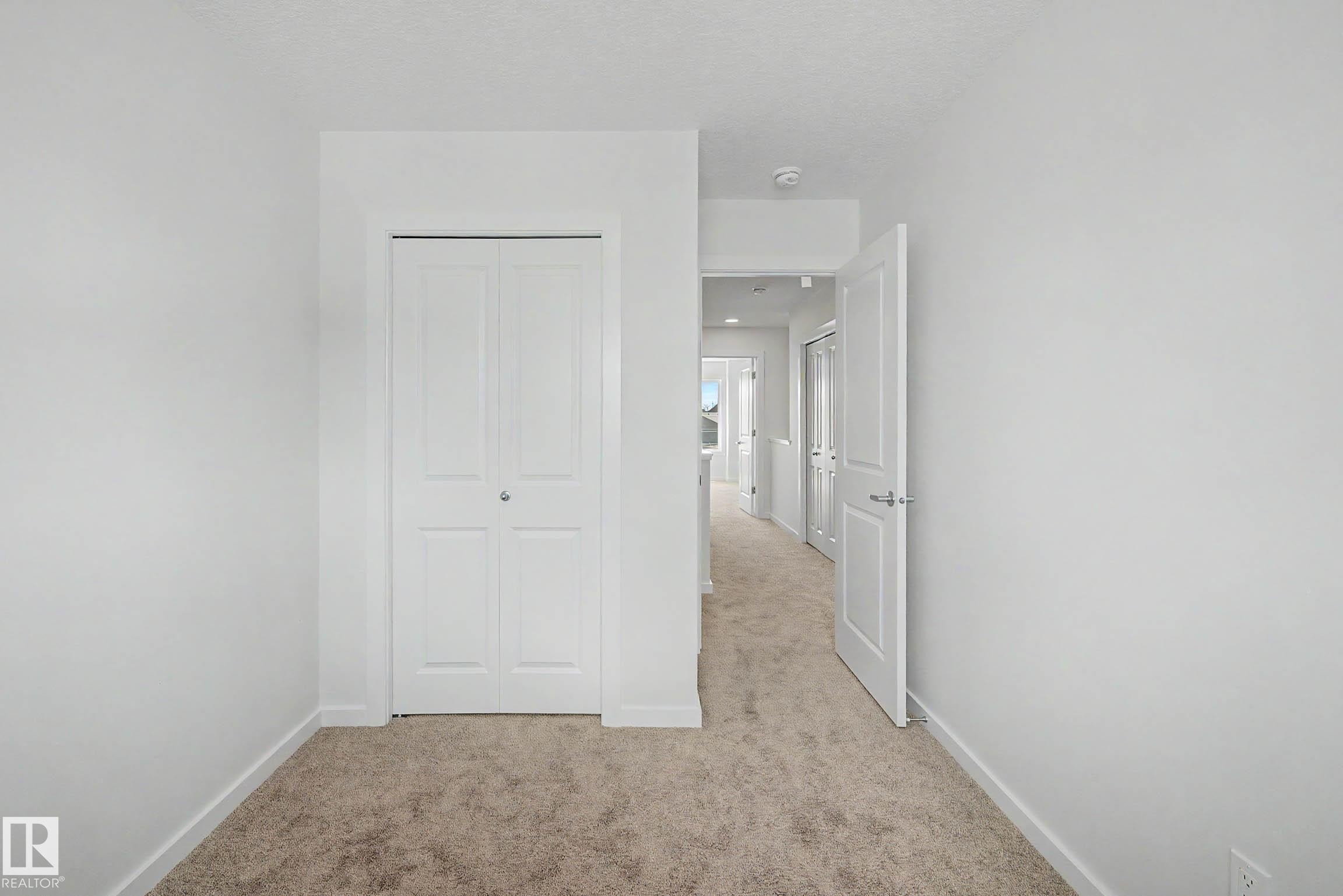 Interior space featuring plush carpet flooring and white painted walls - 720 Southfork Drive, Leduc, AB - Indoor
