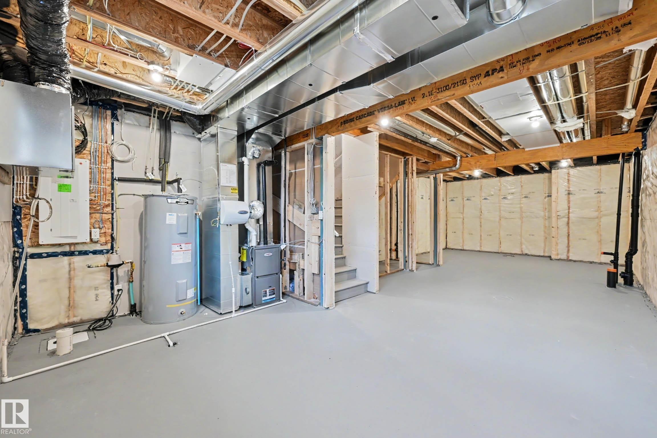 Unfinished basement featuring exposed wood joists, structural framing, and a concrete floor - 720 Southfork Drive, Leduc, AB - Indoor Photo Showing Basement