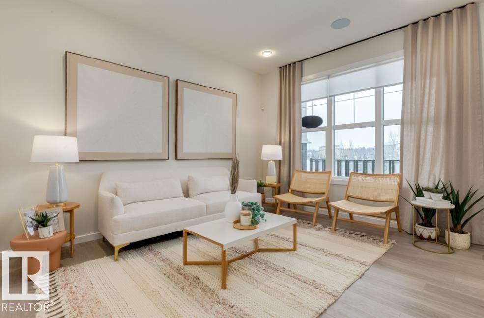 Spacious living area featuring large windows with roller shades, light wood-finish flooring, and recessed ceiling lighting - 720 Southfork Drive, Leduc, AB - Indoor Photo Showing Living Room