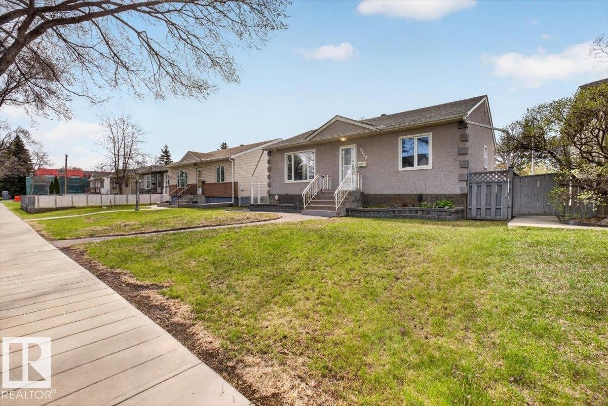 Stucco exterior with decorative quoins, a gabled roof, and white-trimmed windows - 9723 65 Avenue, Edmonton, AB - Outdoor