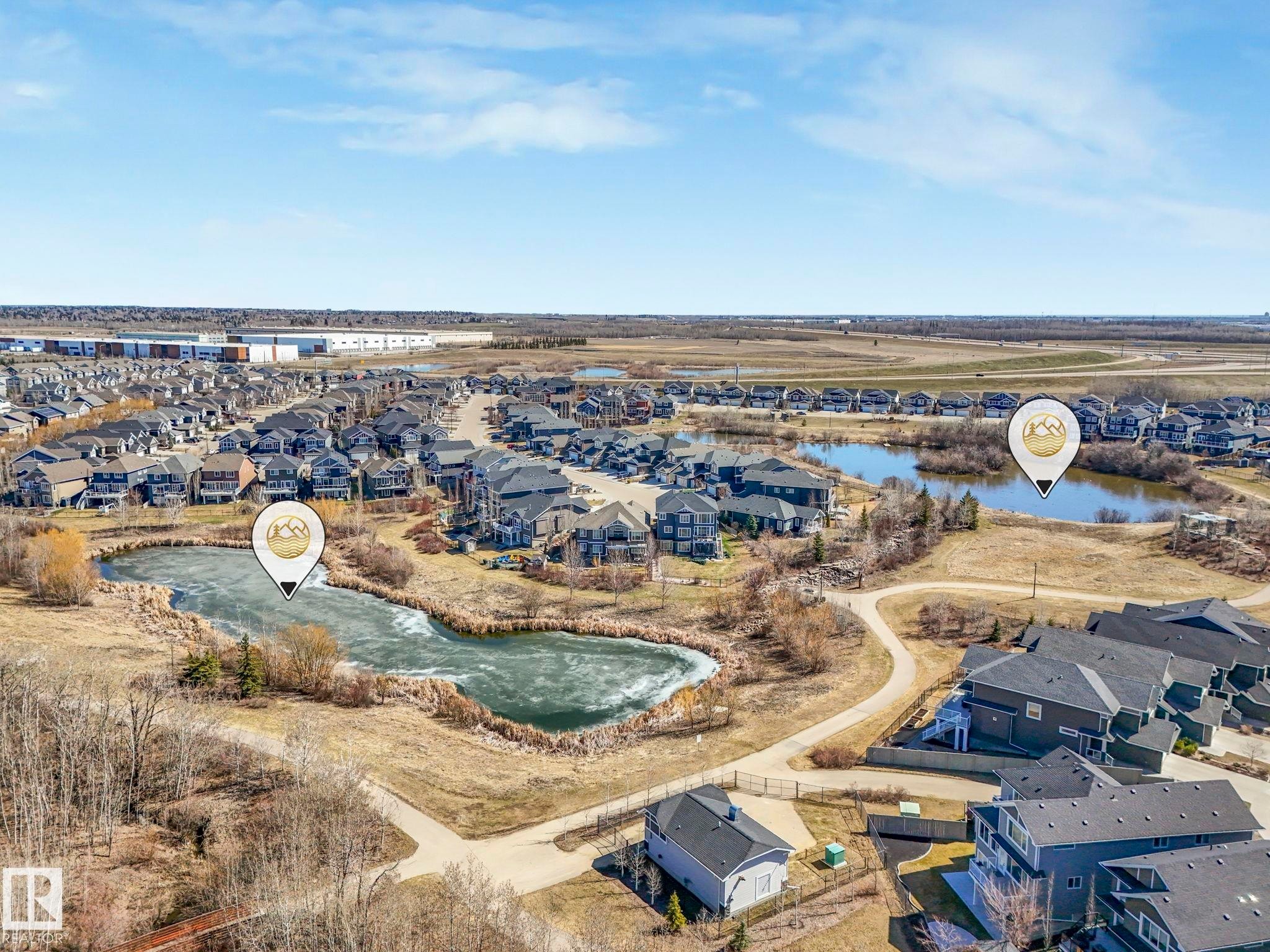 Aerial perspective showcasing a residential community with multiple homes and natural water features - 3817 Robins Crescent, Edmonton, AB - Outdoor With View