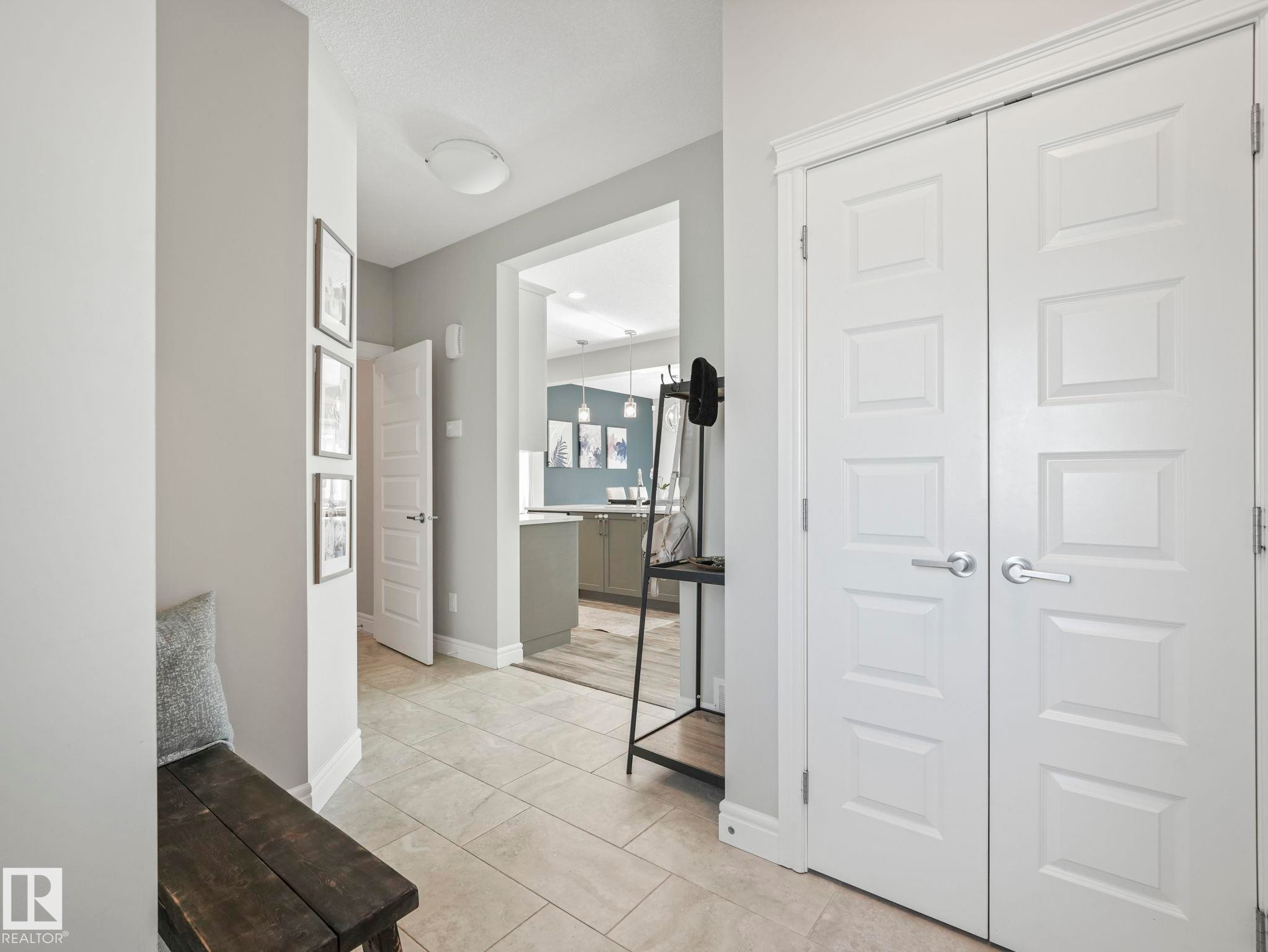 Entryway featuring large format tile flooring, white six-panel doors, white trim, and light gray walls - 3817 Robins Crescent, Edmonton, AB - Indoor Photo Showing Other Room