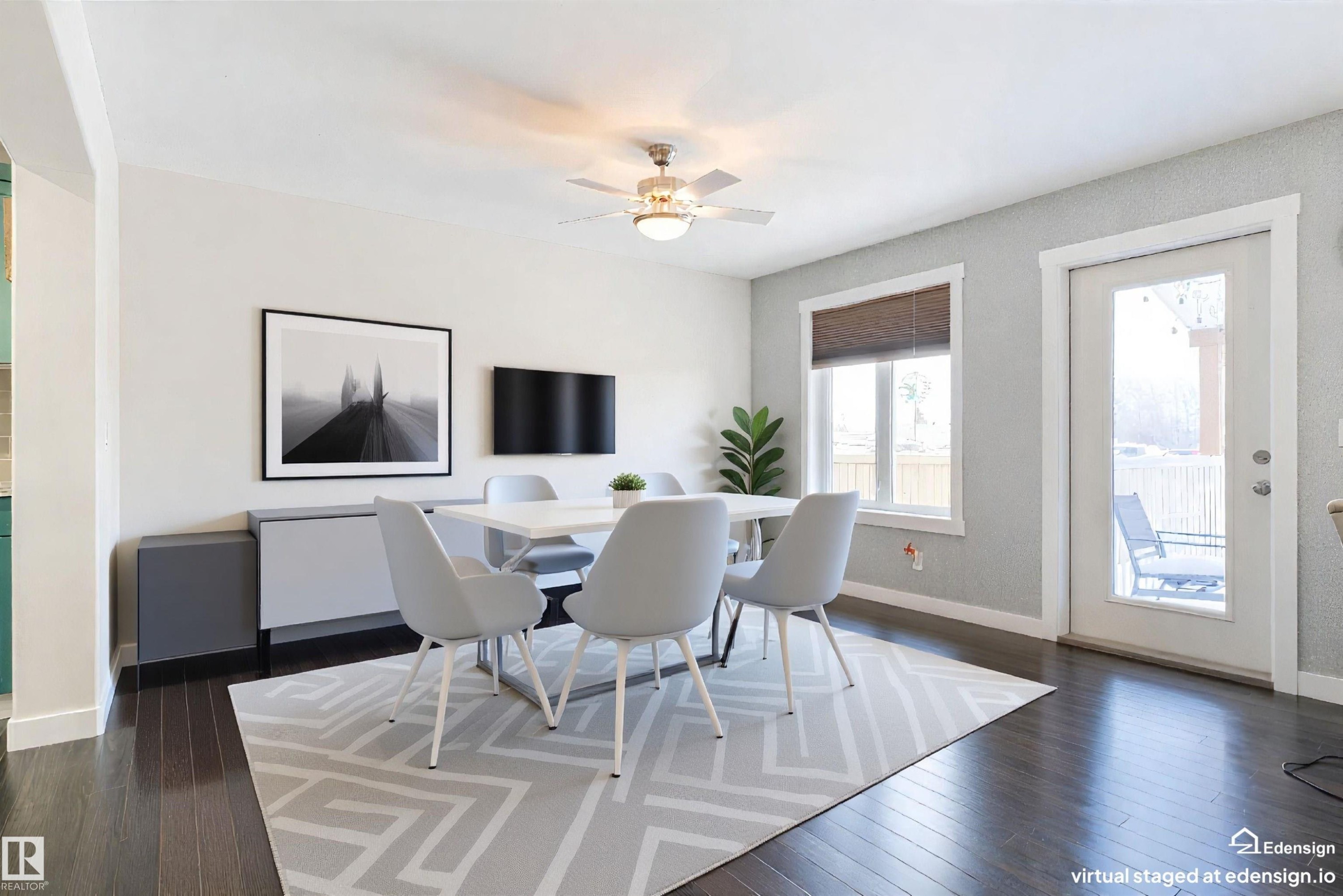Virtually stagged. Dining area with dark wood-finish flooring, a ceiling fan, and light gray textured accent wall - 4914 47 Street, Redwater, AB - Indoor