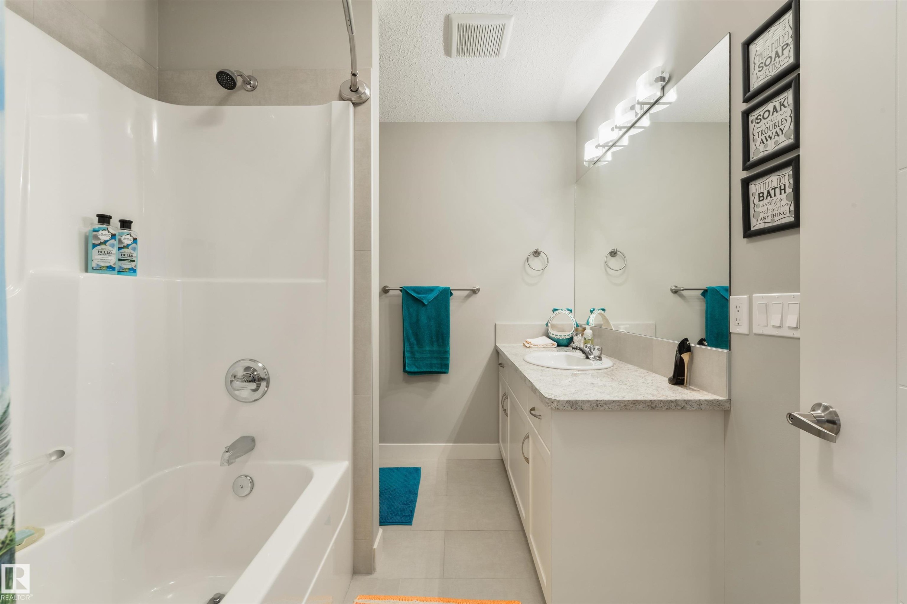 Full bathroom featuring a white tub and shower combination with chrome fixtures - 4914 47 Street, Redwater, AB - Indoor Photo Showing Bathroom