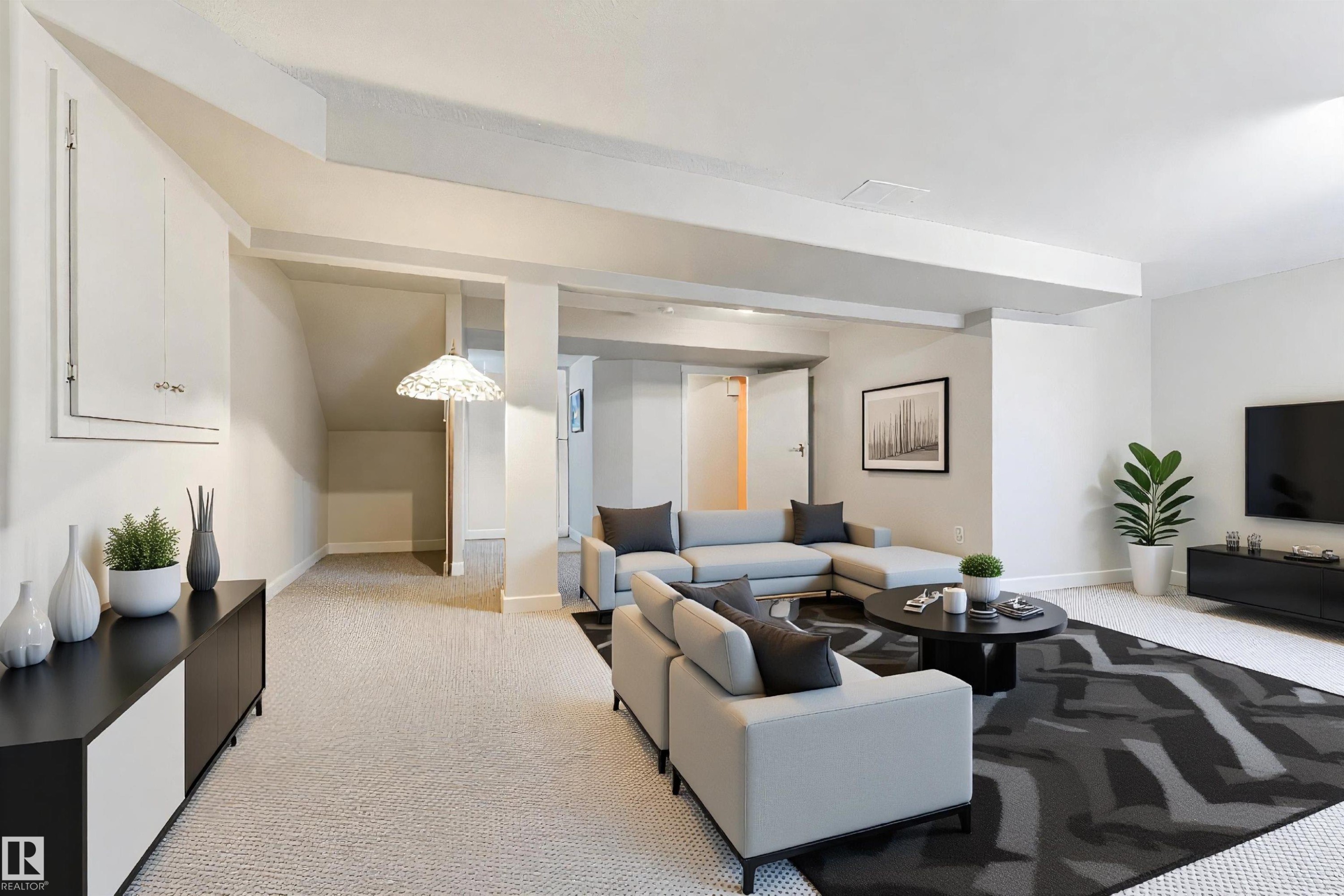 Spacious lower-level area with light-toned carpeting throughout - 4914 47 Street, Redwater, AB - Indoor Photo Showing Living Room