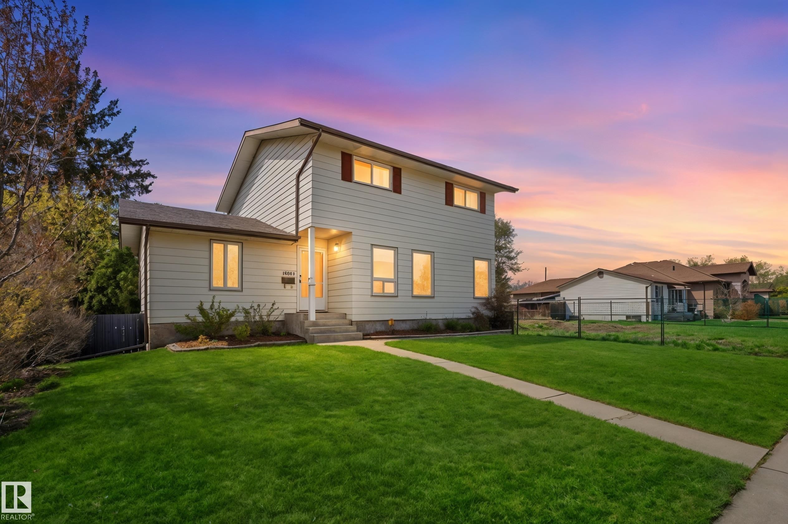Two-story residence featuring light-colored siding and a dark shingle roof - 10502 158 Street, Edmonton, AB - Outdoor