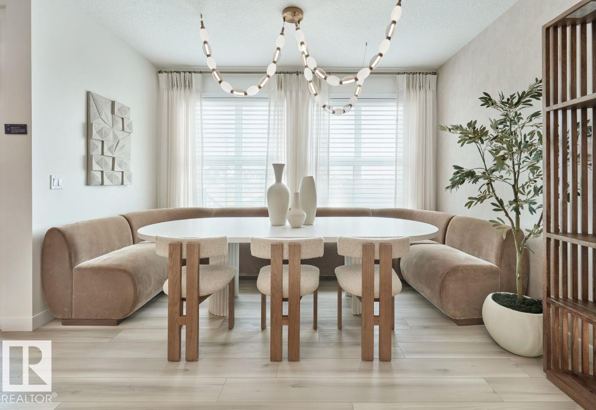 Dining area with a textured ceiling and light wood finished floors - 2131 194 Street Nw, Edmonton, AB - Indoor Photo Showing Dining Room